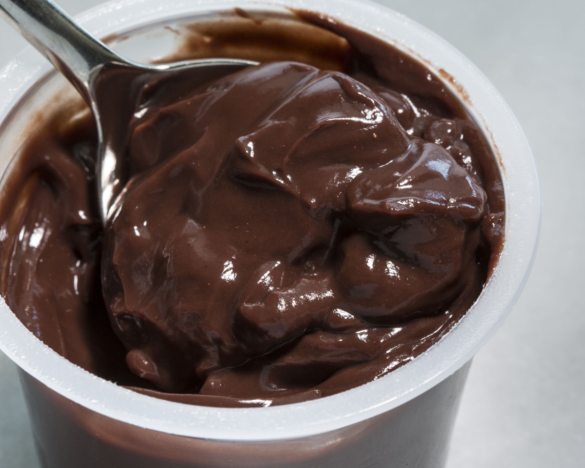 spoon in chocolate pudding cup