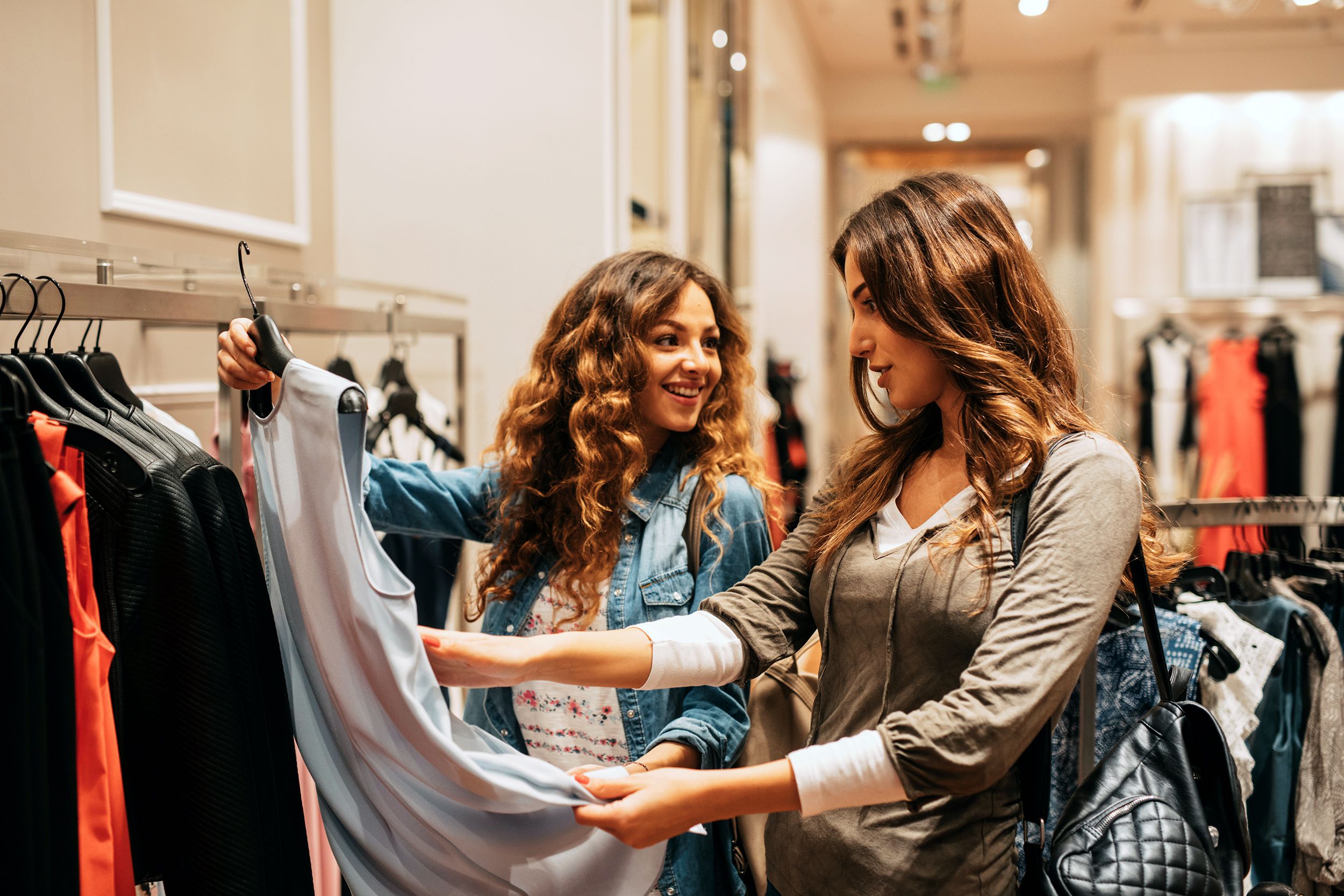 two friends shopping for clothes