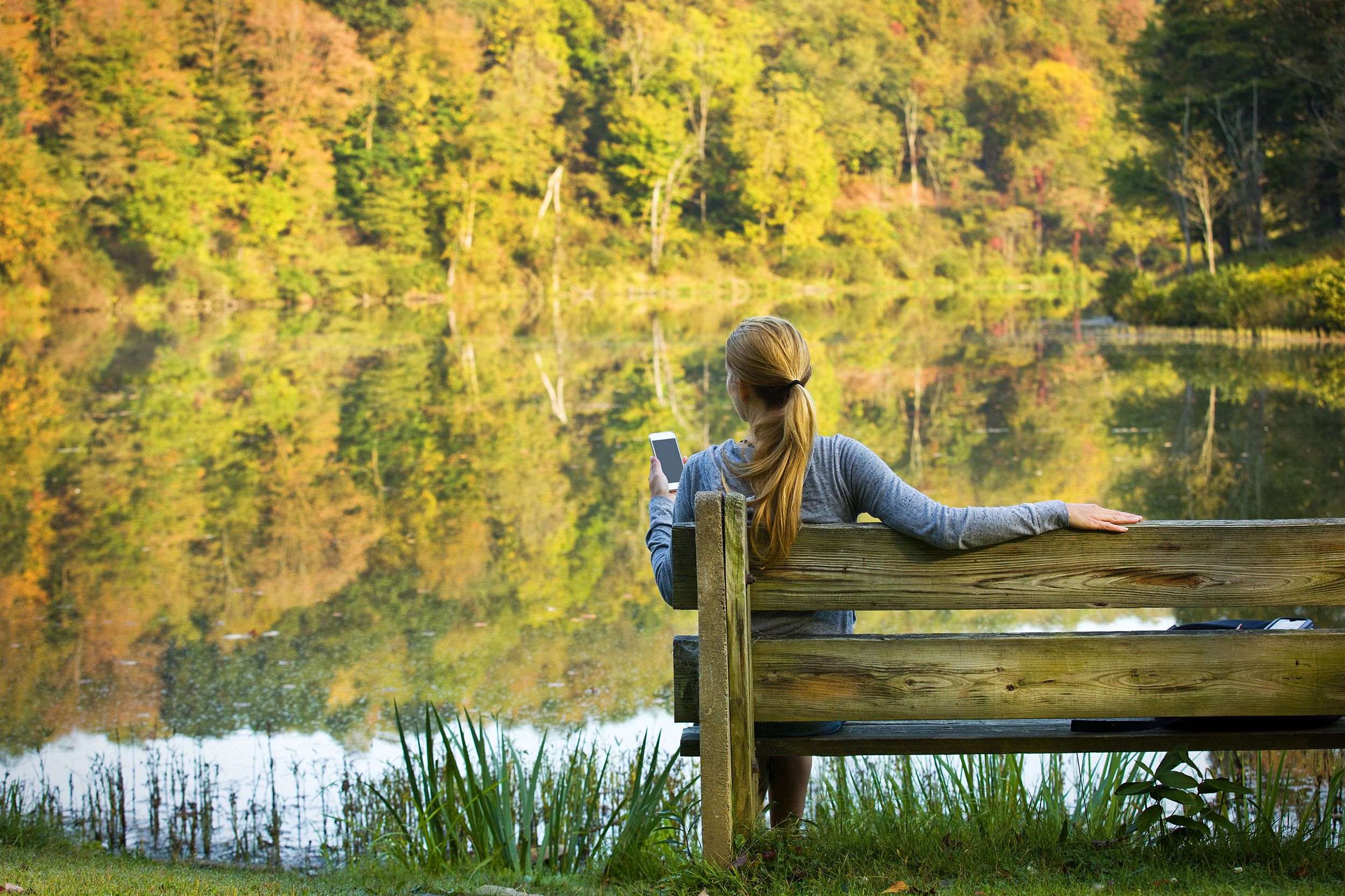 woman texting outdoors on beautiful fall day in West Virginia