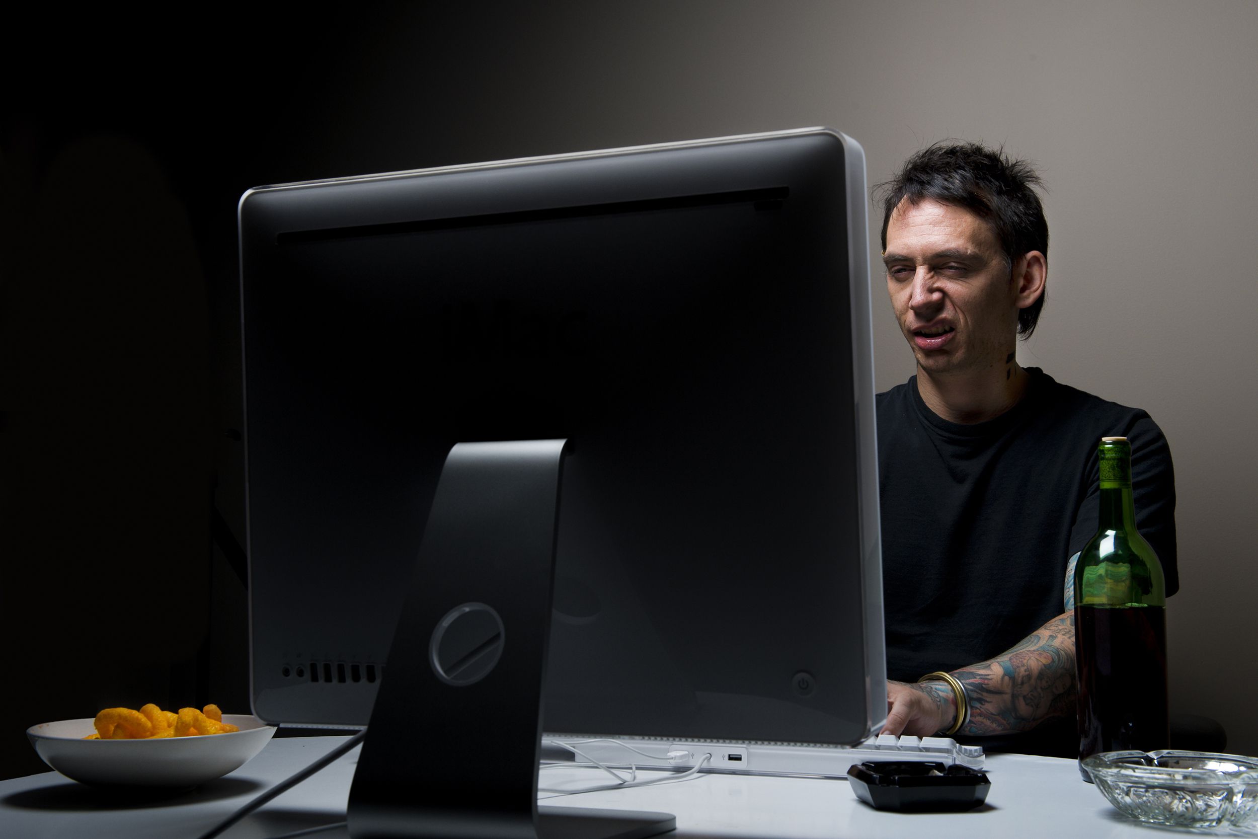 nefarious man on computer in room