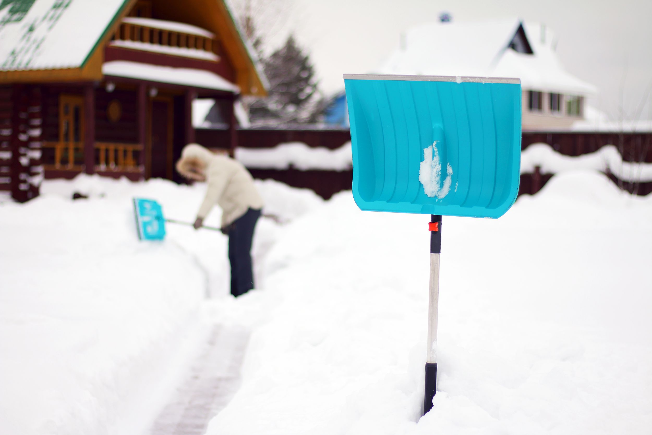 shovel for clearing tracks from snow stands in a snowdrift