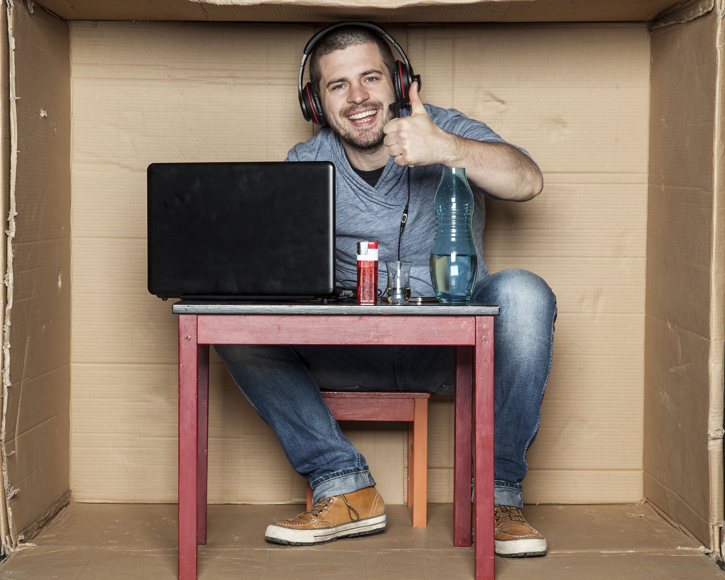 unemployed student sitting in his room playing video games