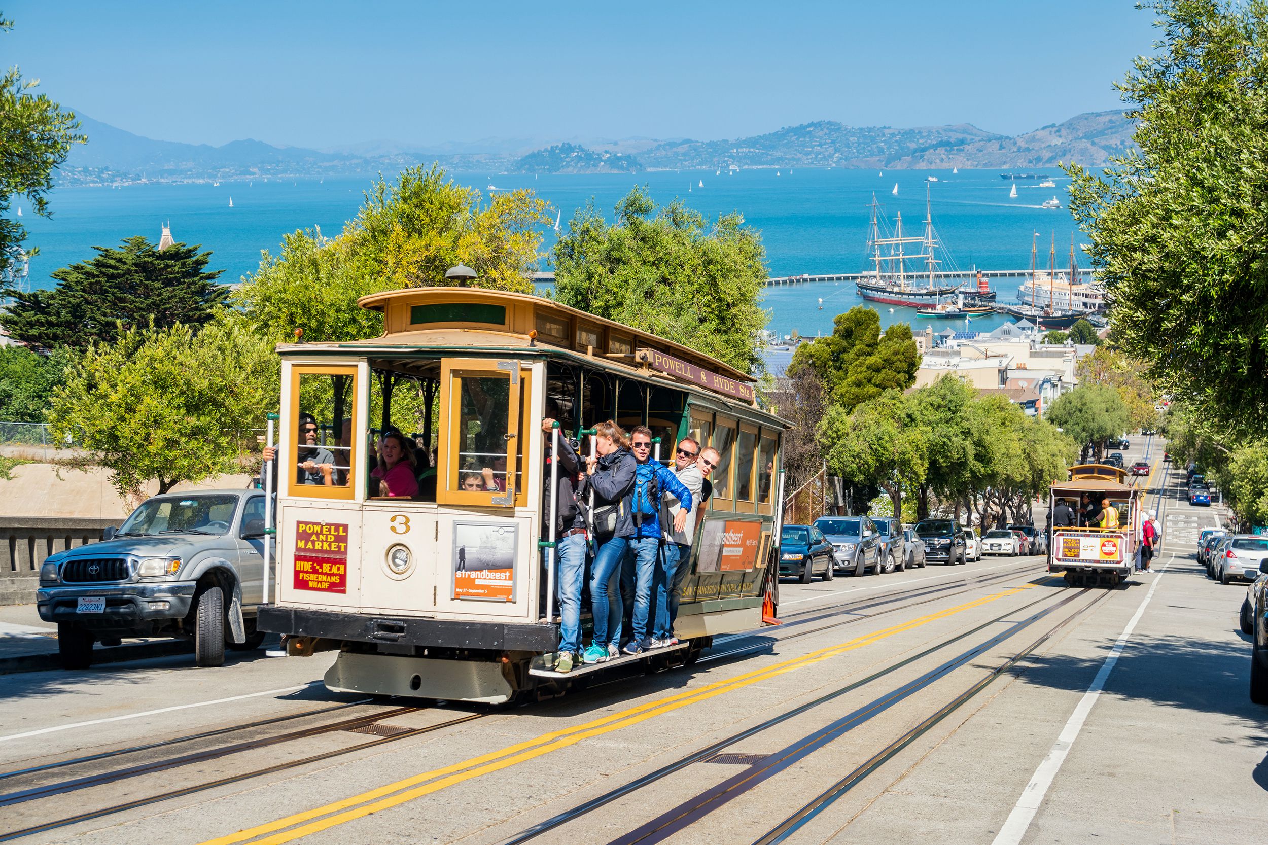 people ride cable car in San Francisco
