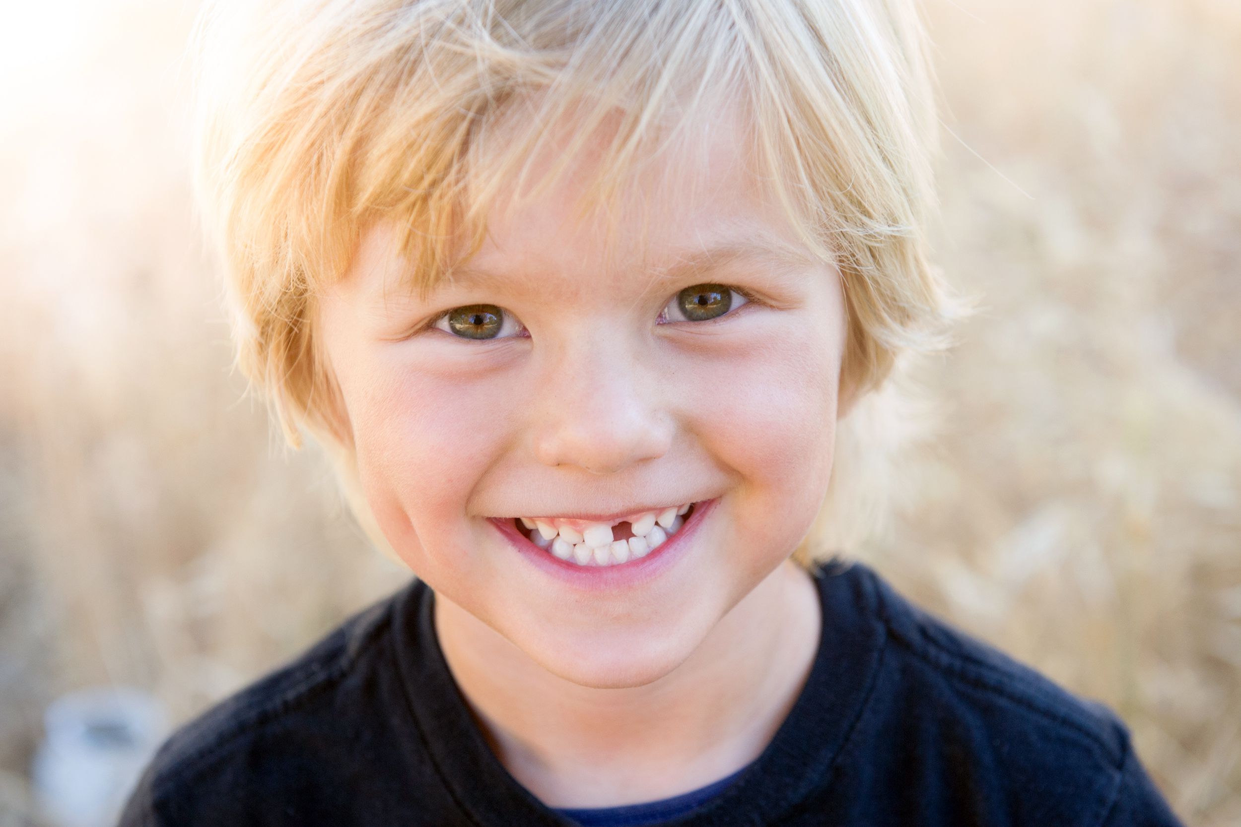 smiling little boy with missing tooth