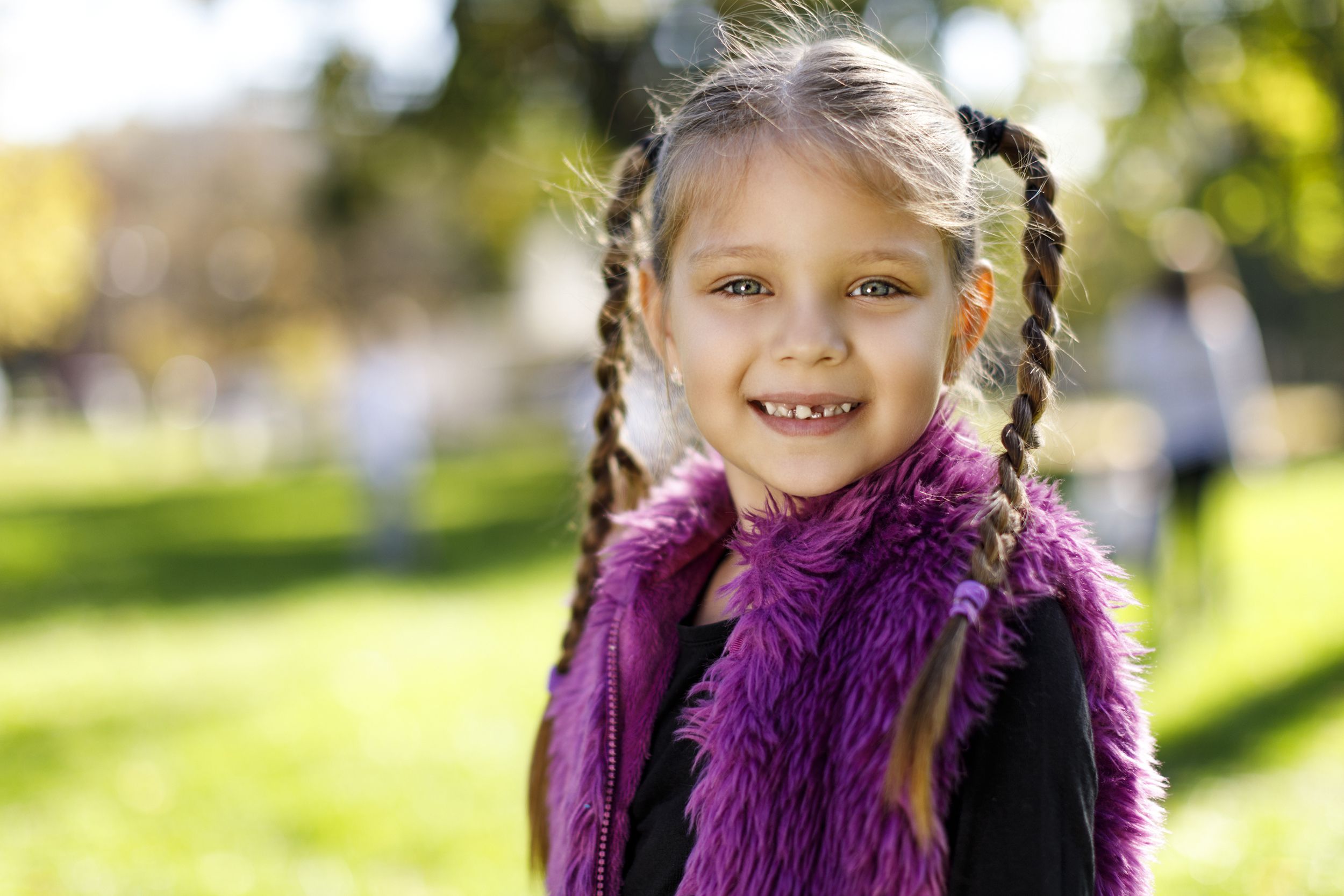 little girl smiling with missing tooth