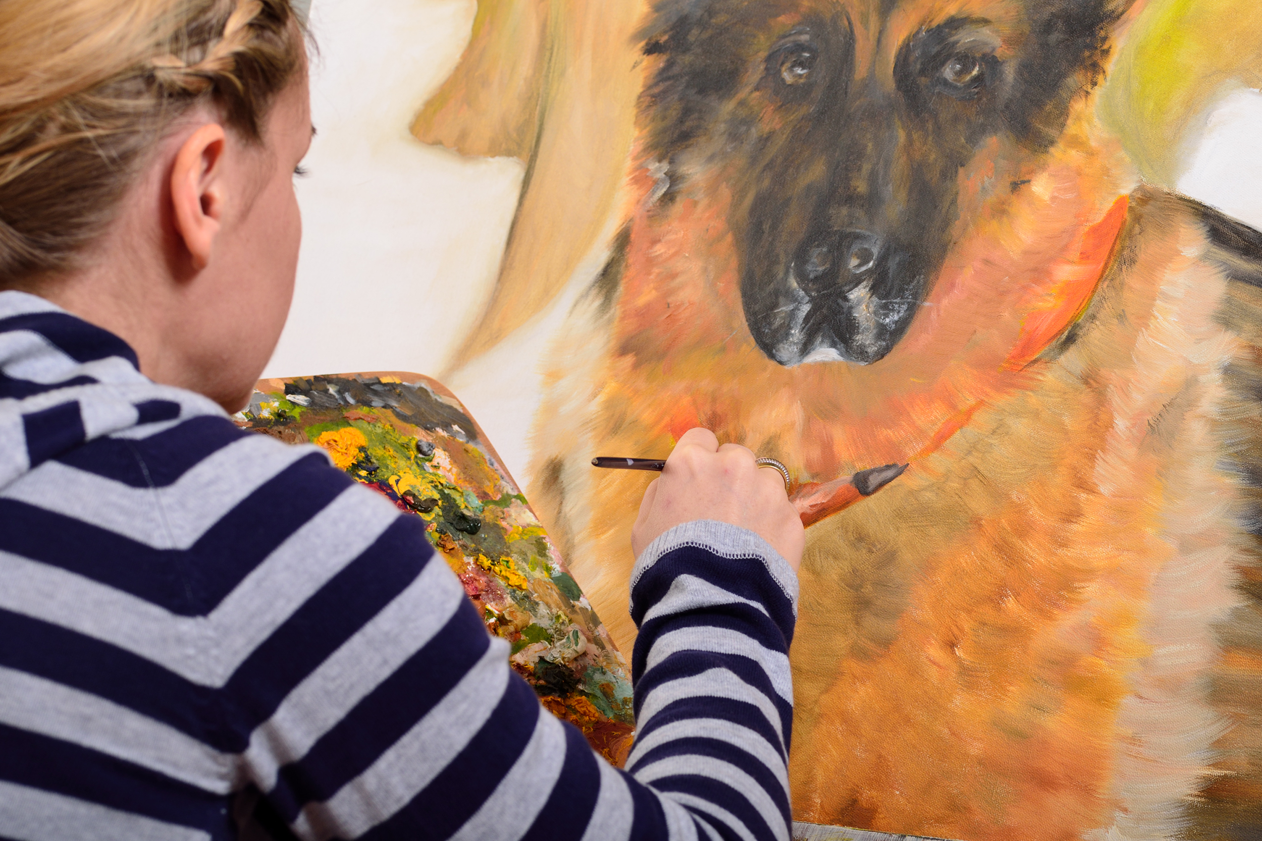 Woman painting a dog