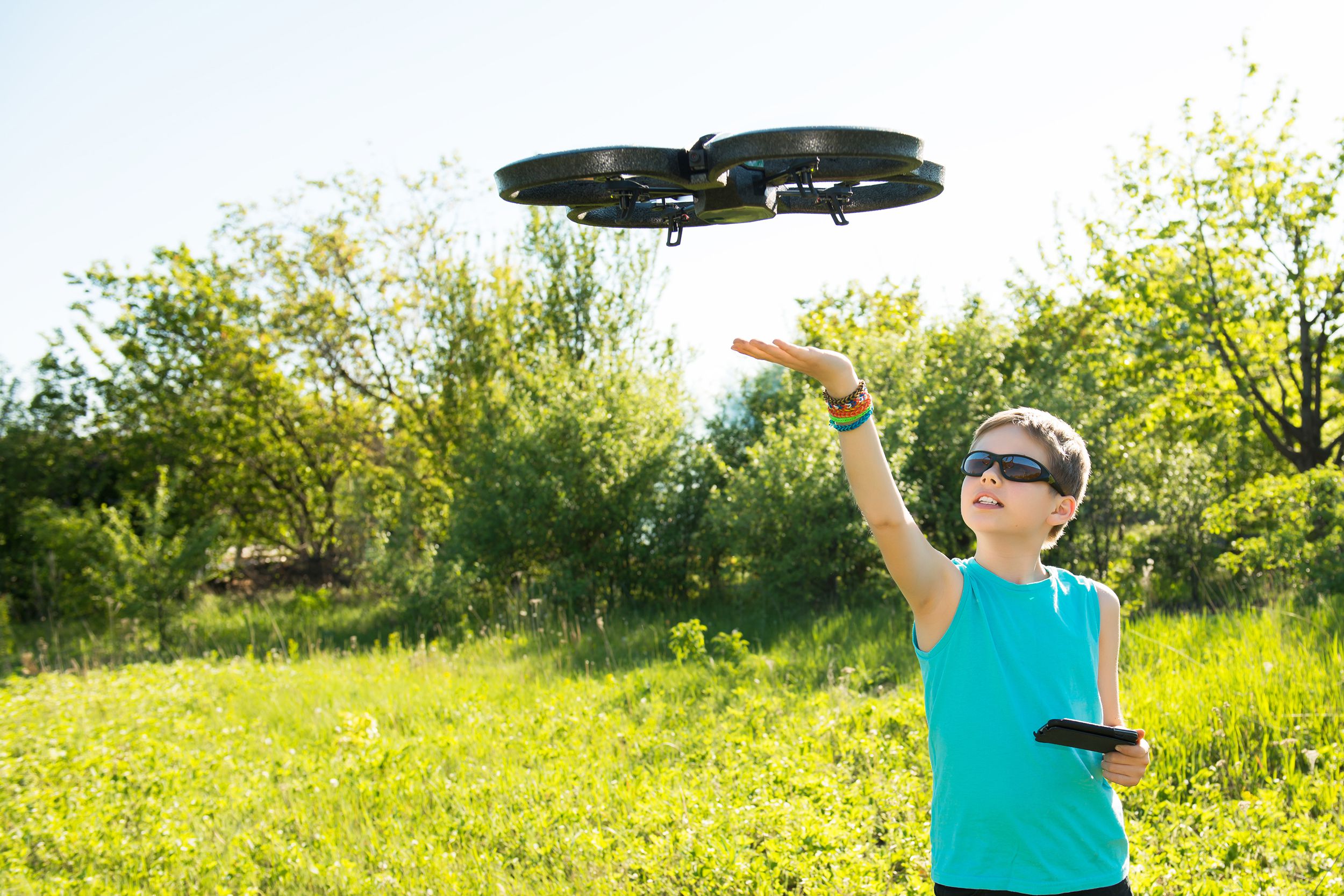 Young boy playing with his drone