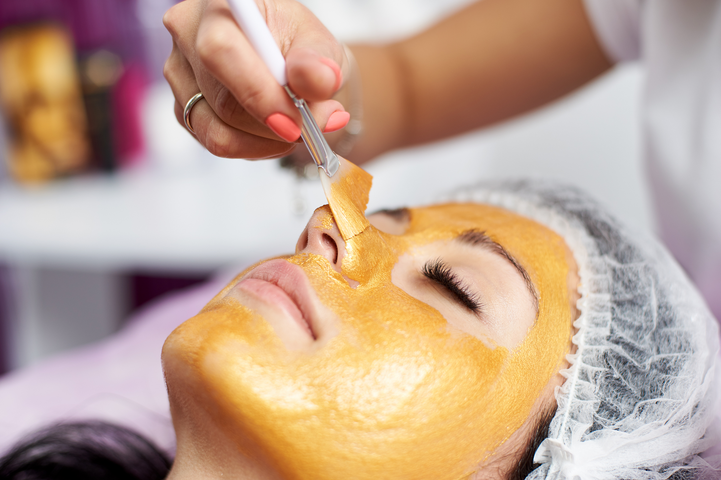 Woman getting a gold facial