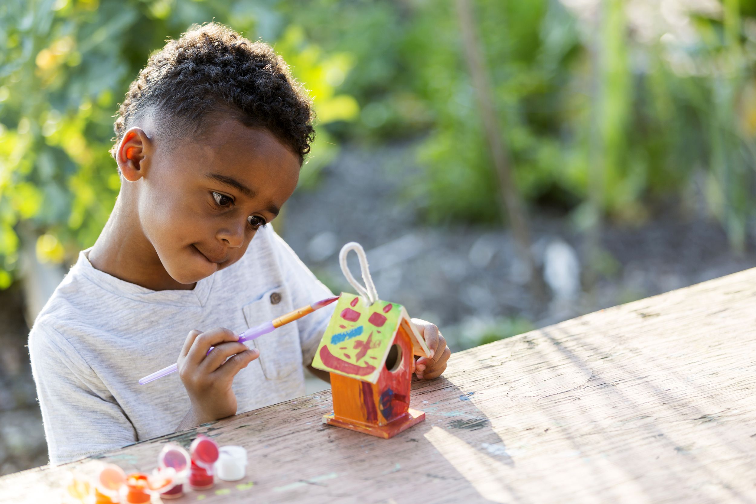 Young boy making a bird house