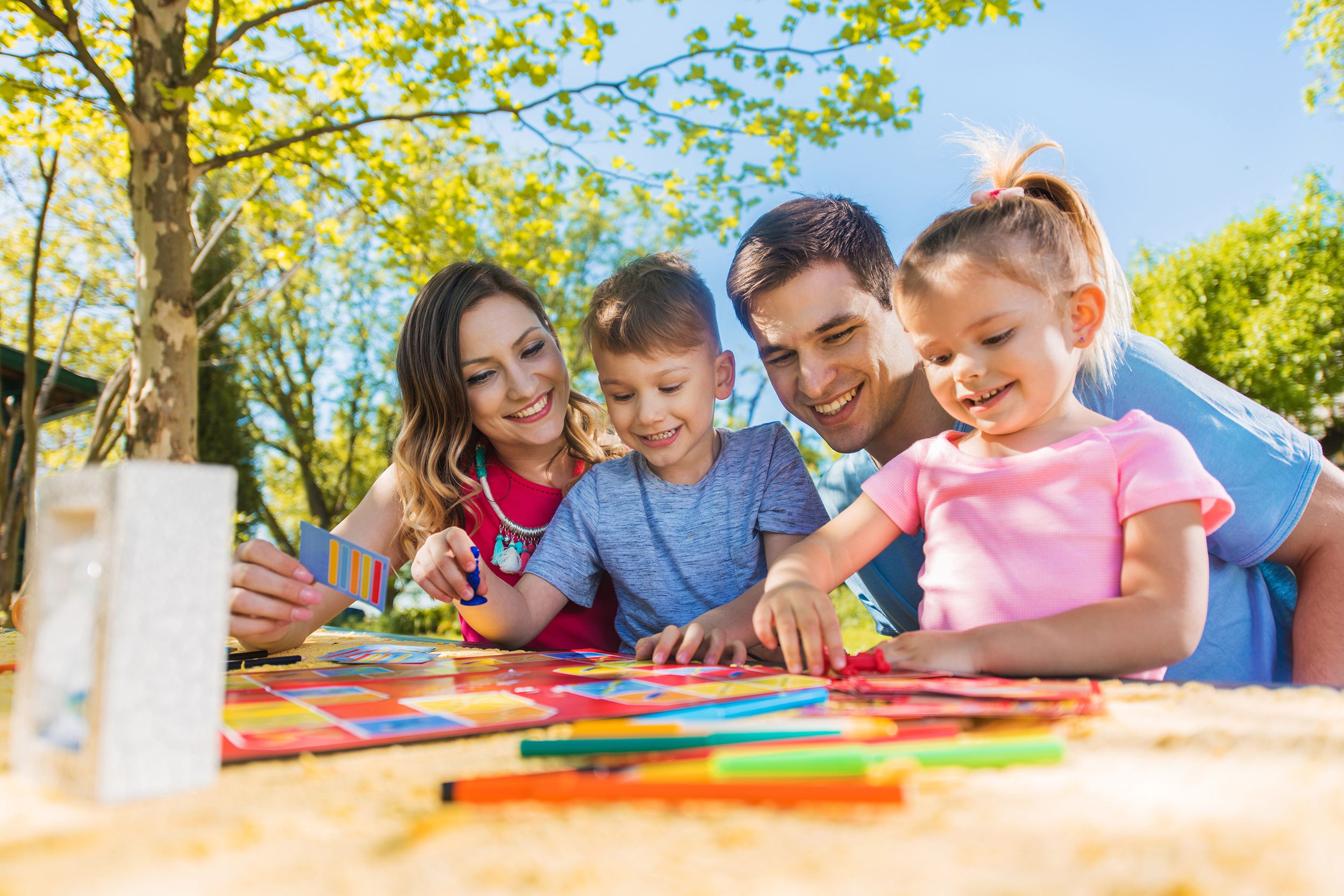 Family playing a board game outside