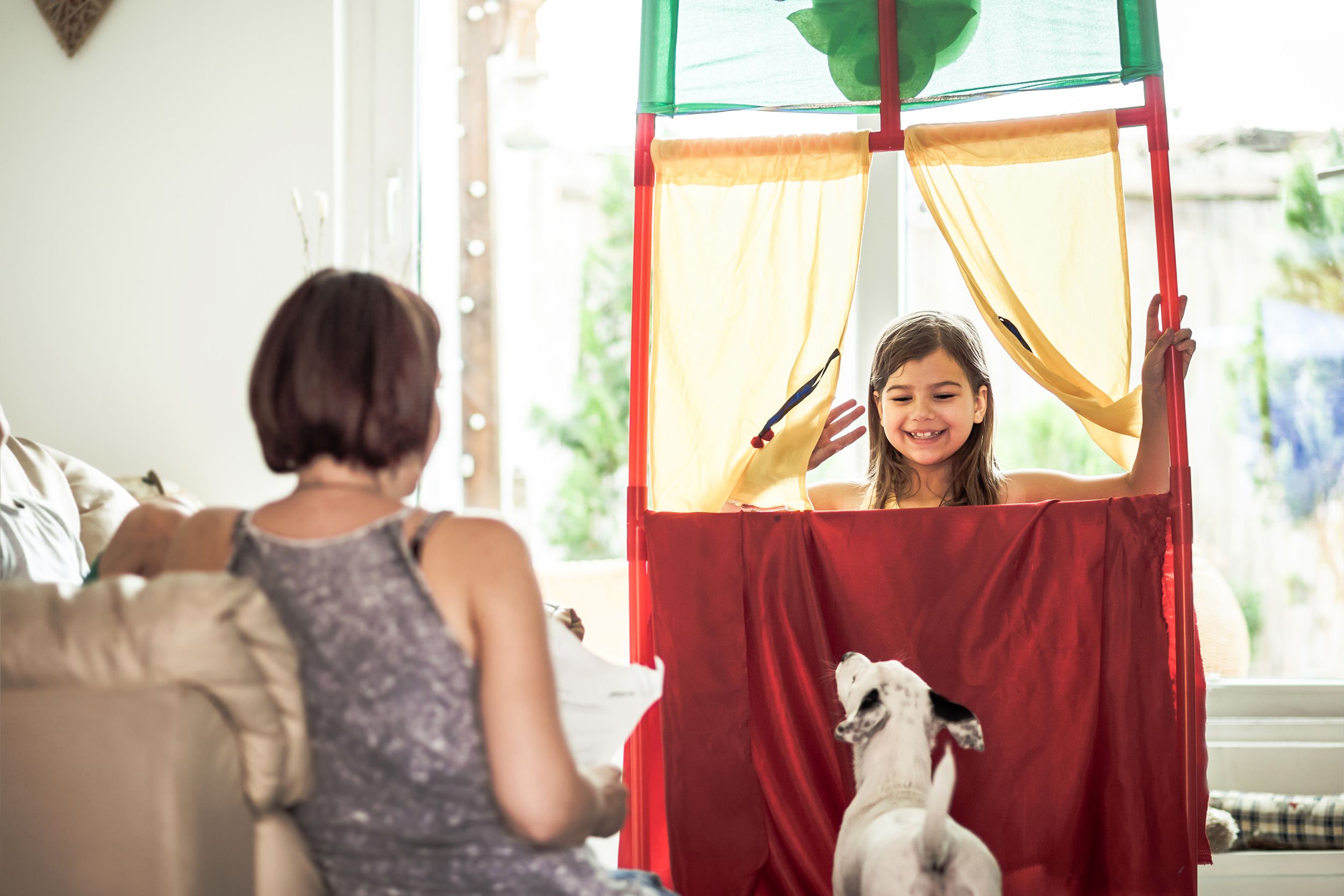 Little girl putting on a play in her living room