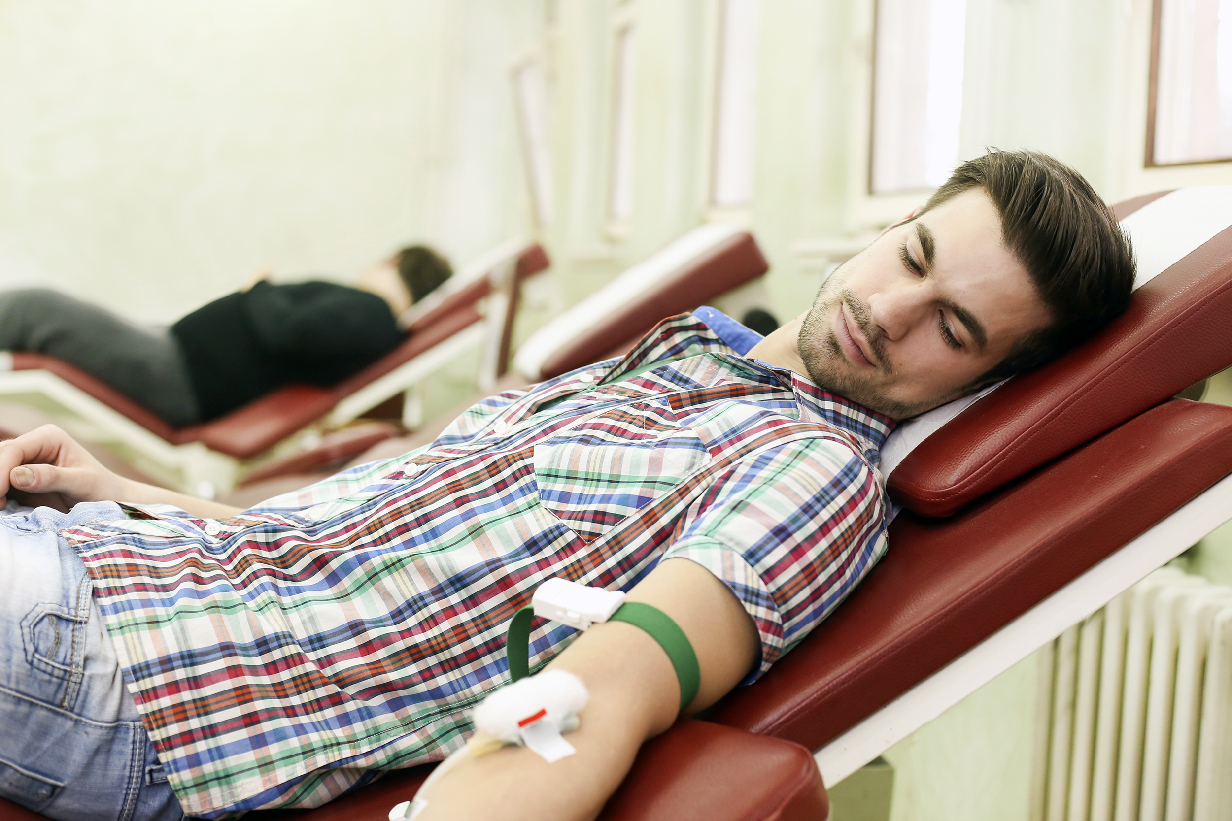 Young man giving blood