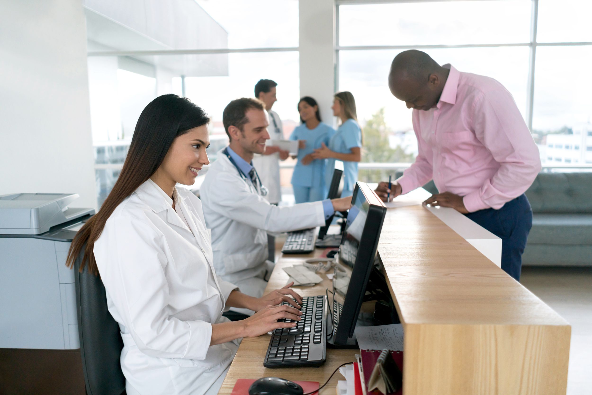 patient at medical clinic reception desk