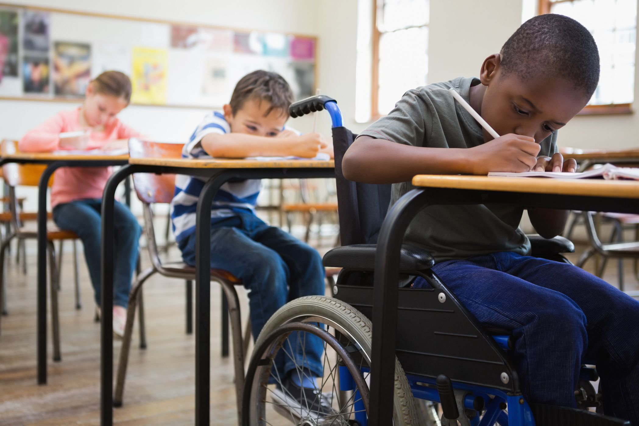 pupils in classroom writing