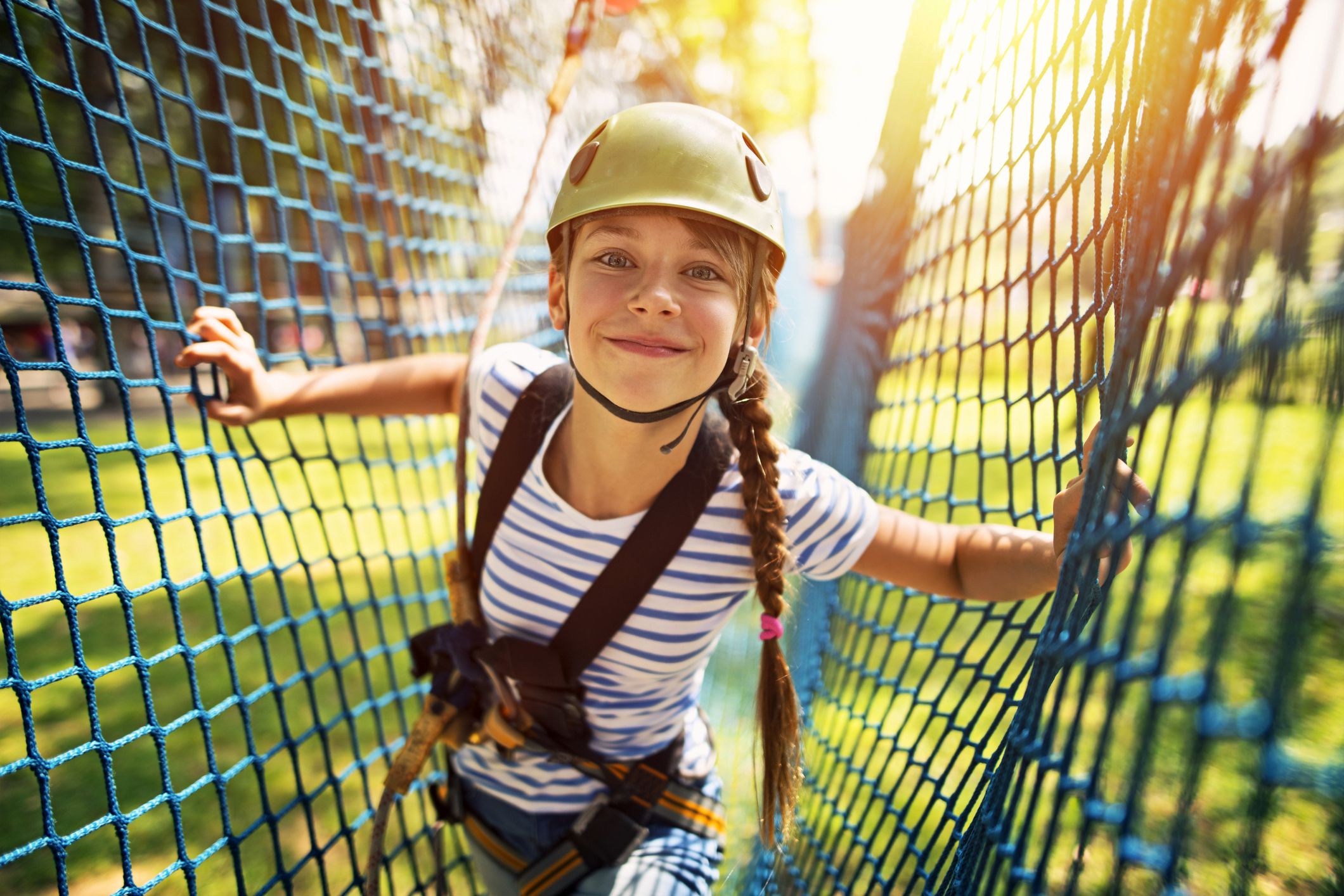 child smiling on ropes course