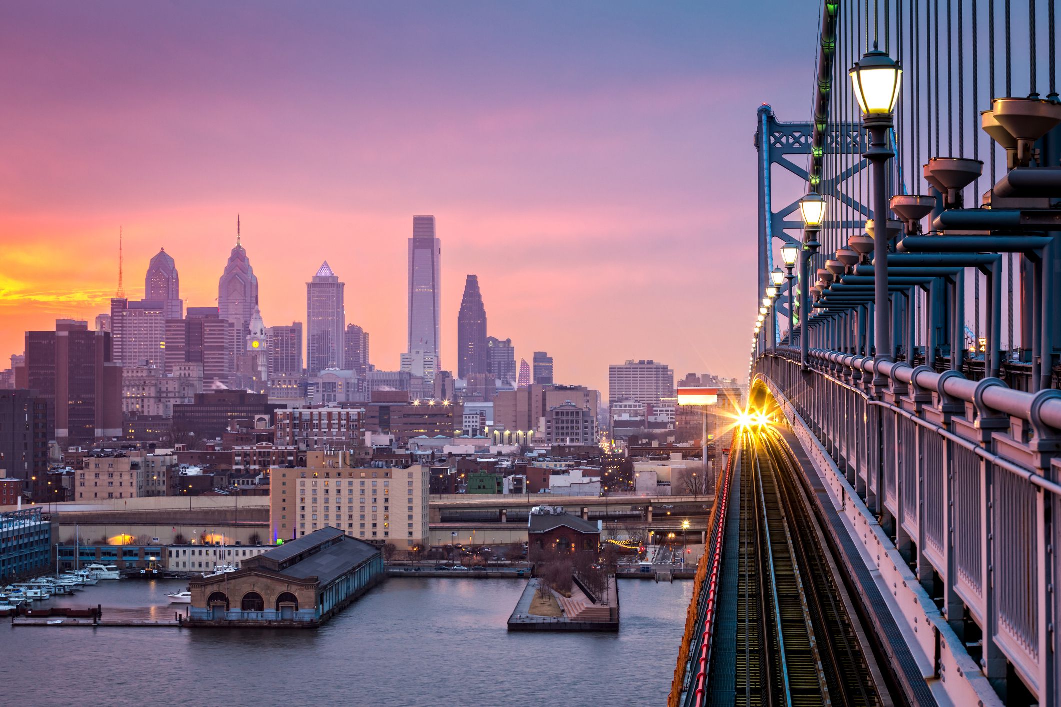 philadelphia train over bridge at sunset