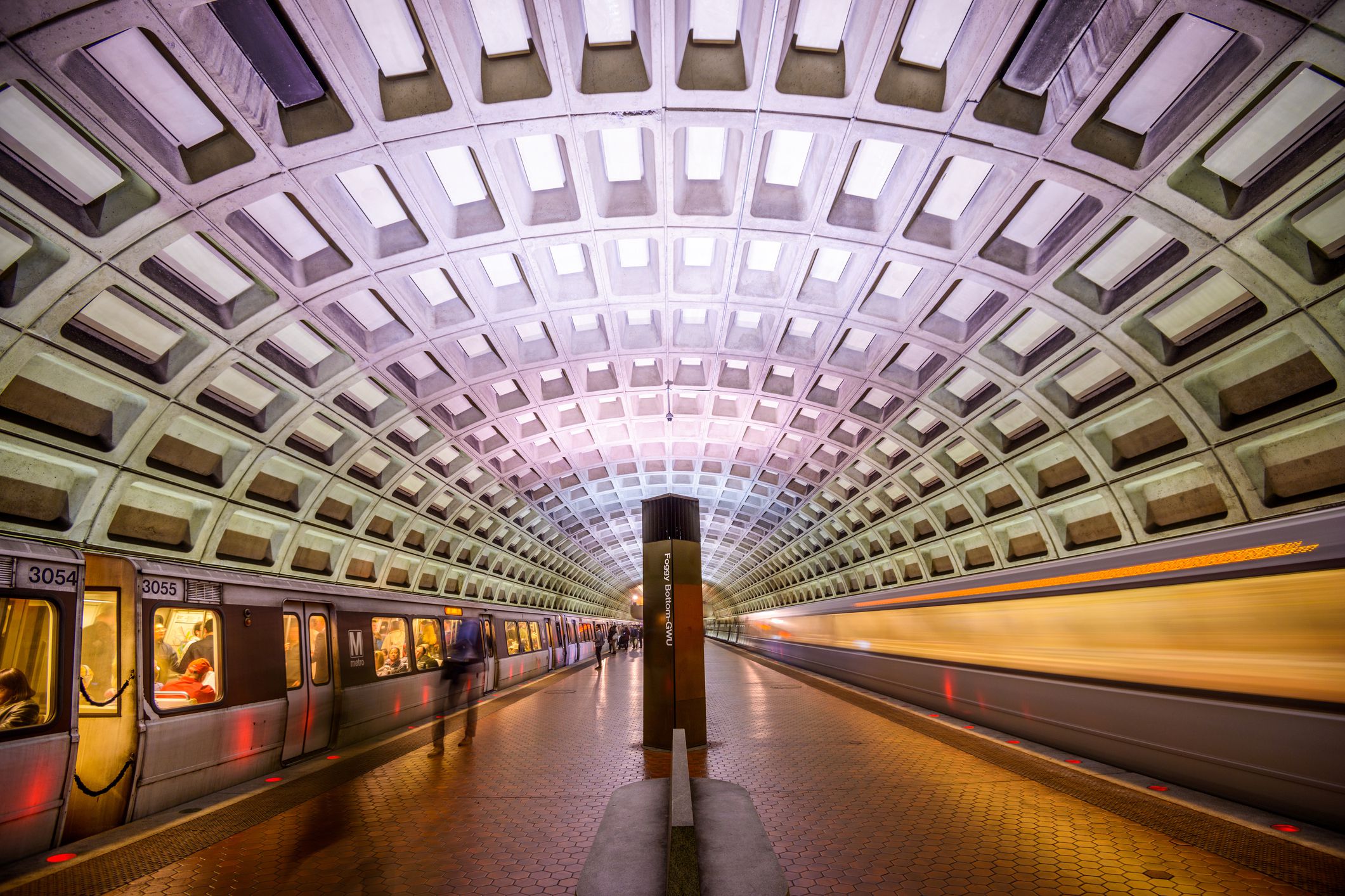passengers getting on train at underground metro station