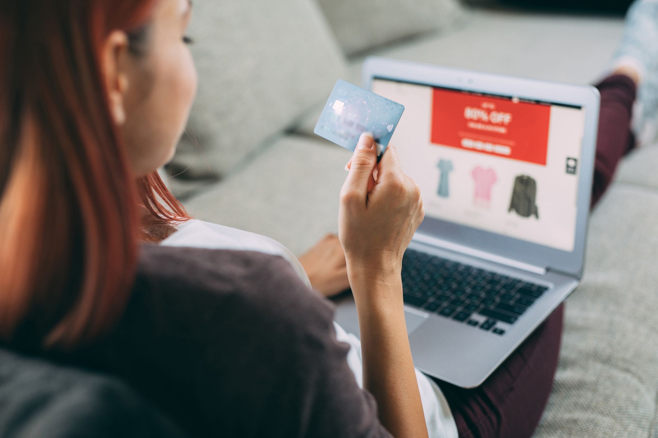 woman online shopping holding credit card
