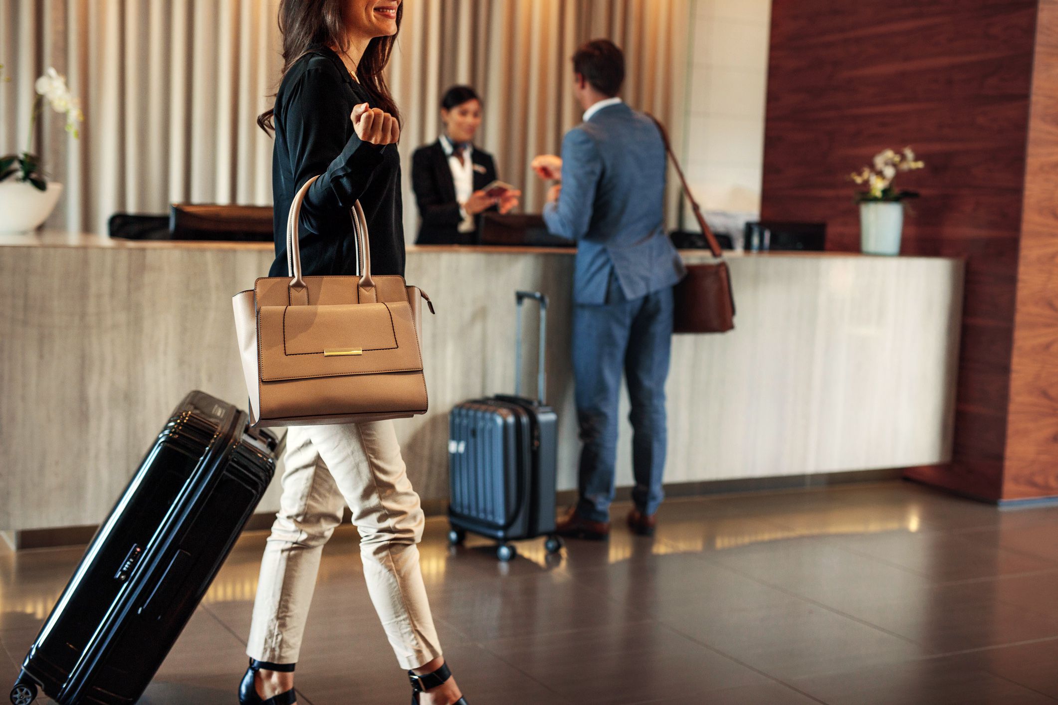 guests with luggage checking into hotel
