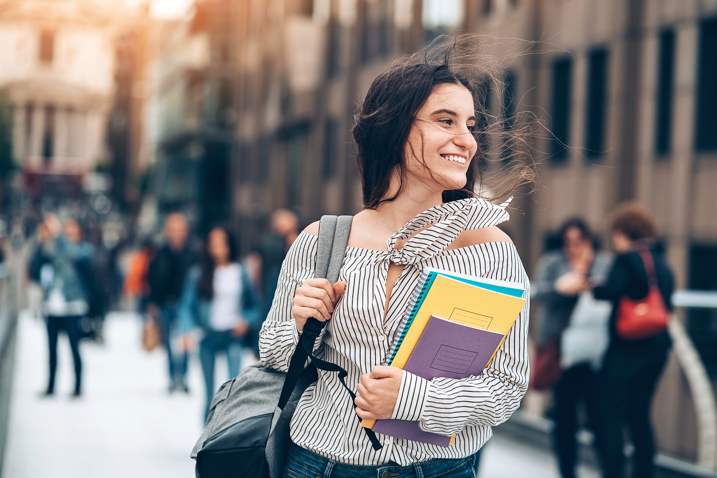 Young college student walking in the street