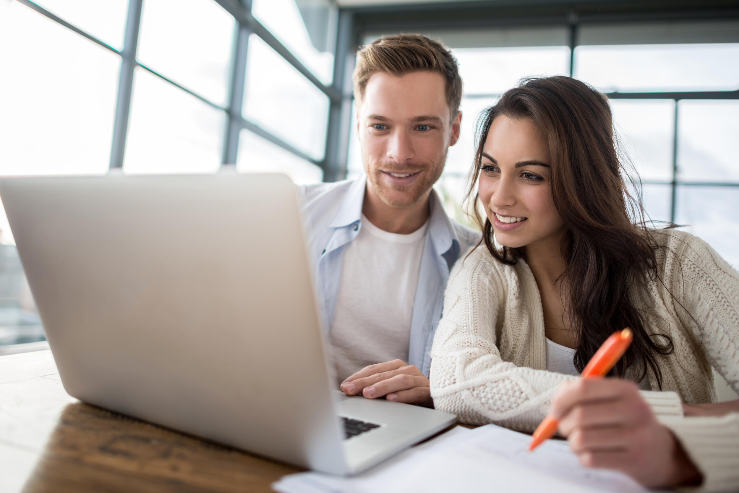 Couple using a laptop together