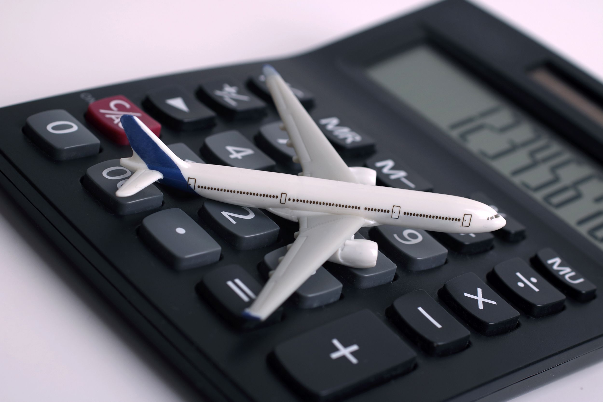 Toy airplane on a calculator