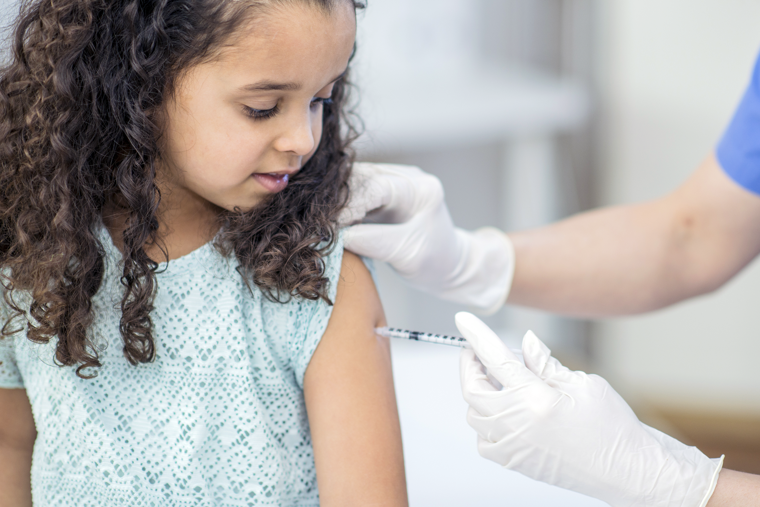 Young girl getting a vaccination