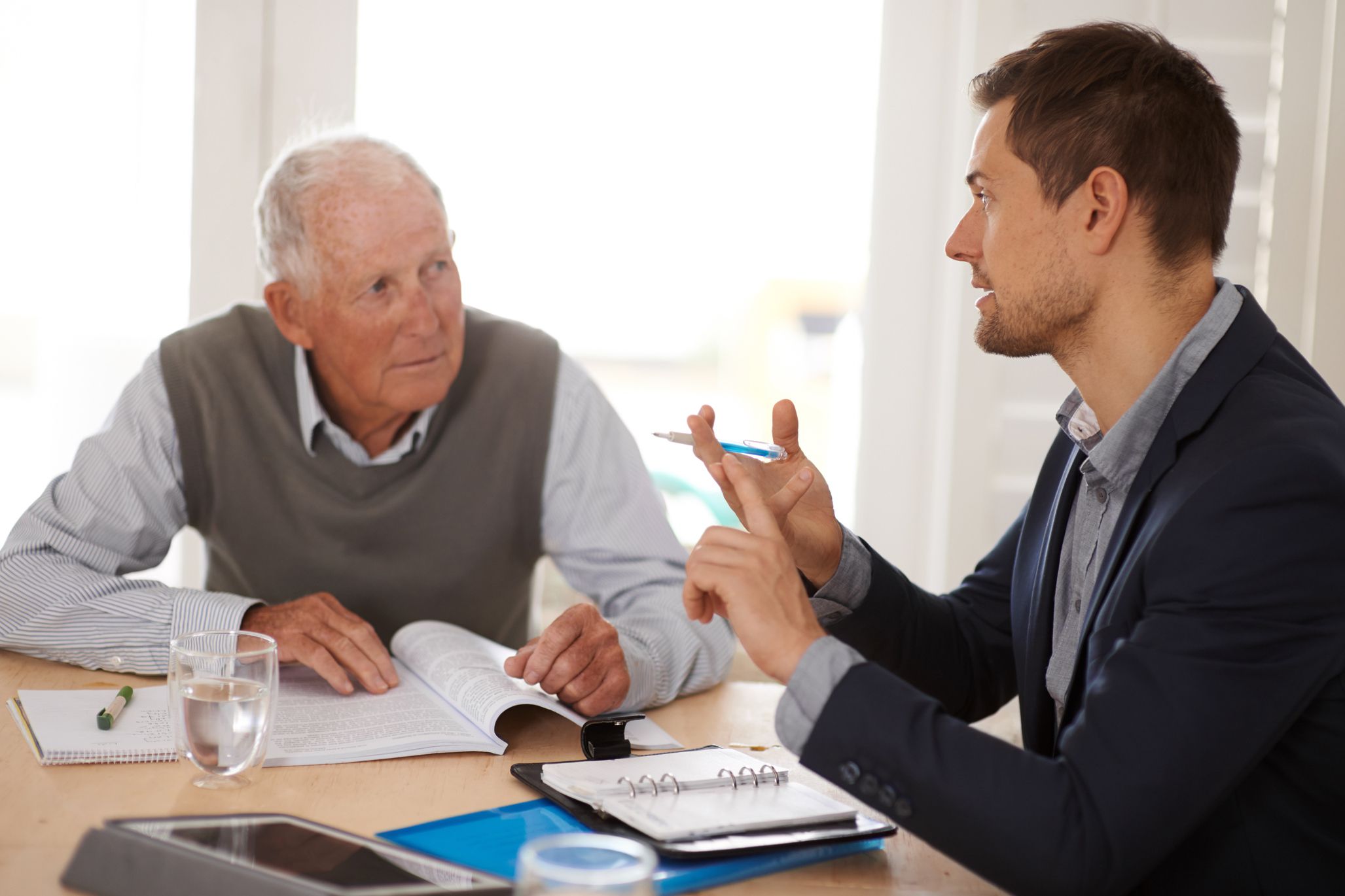 tax attorney going over options with elderly man