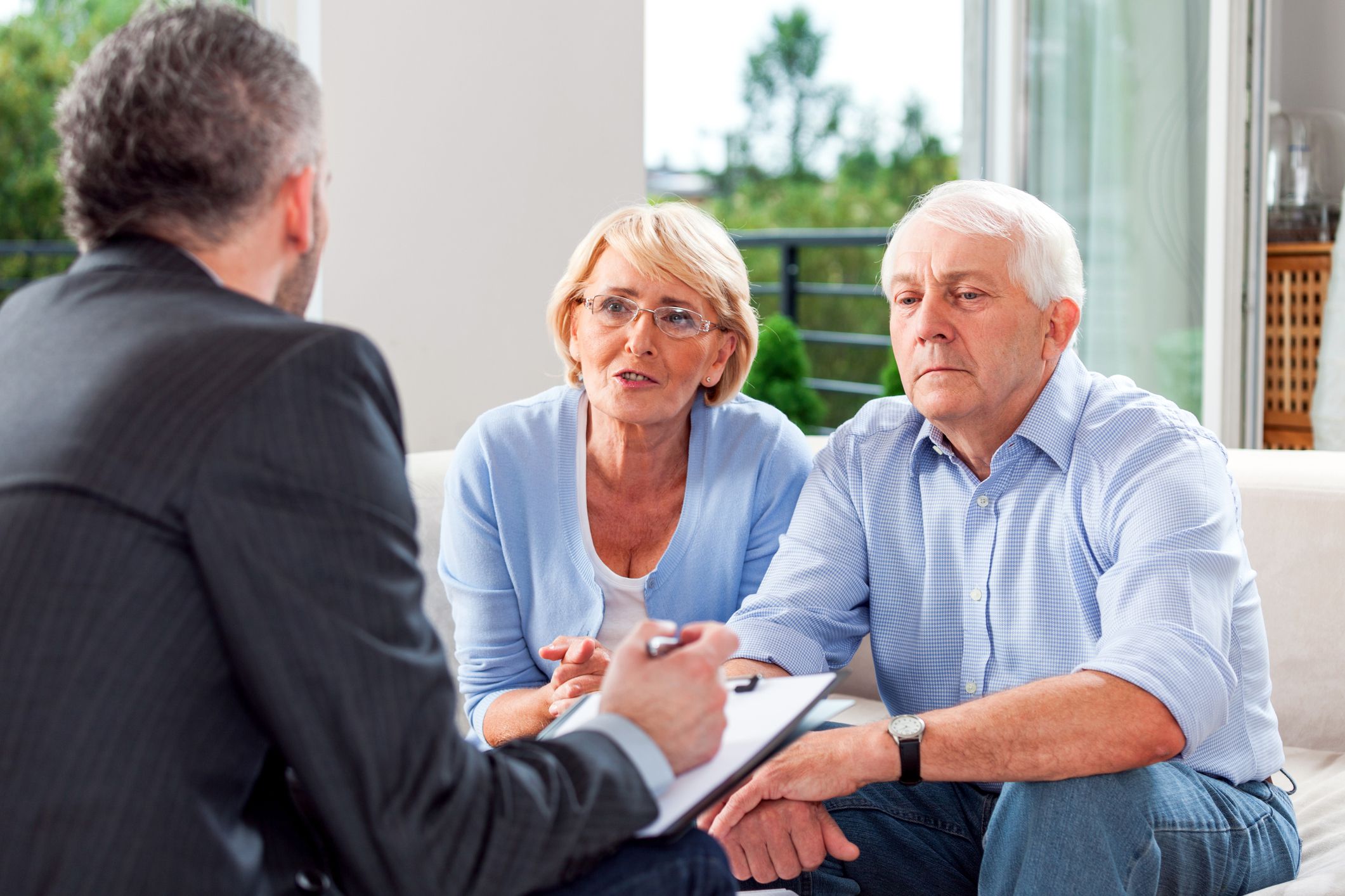 senior couple speaking with financial advisor