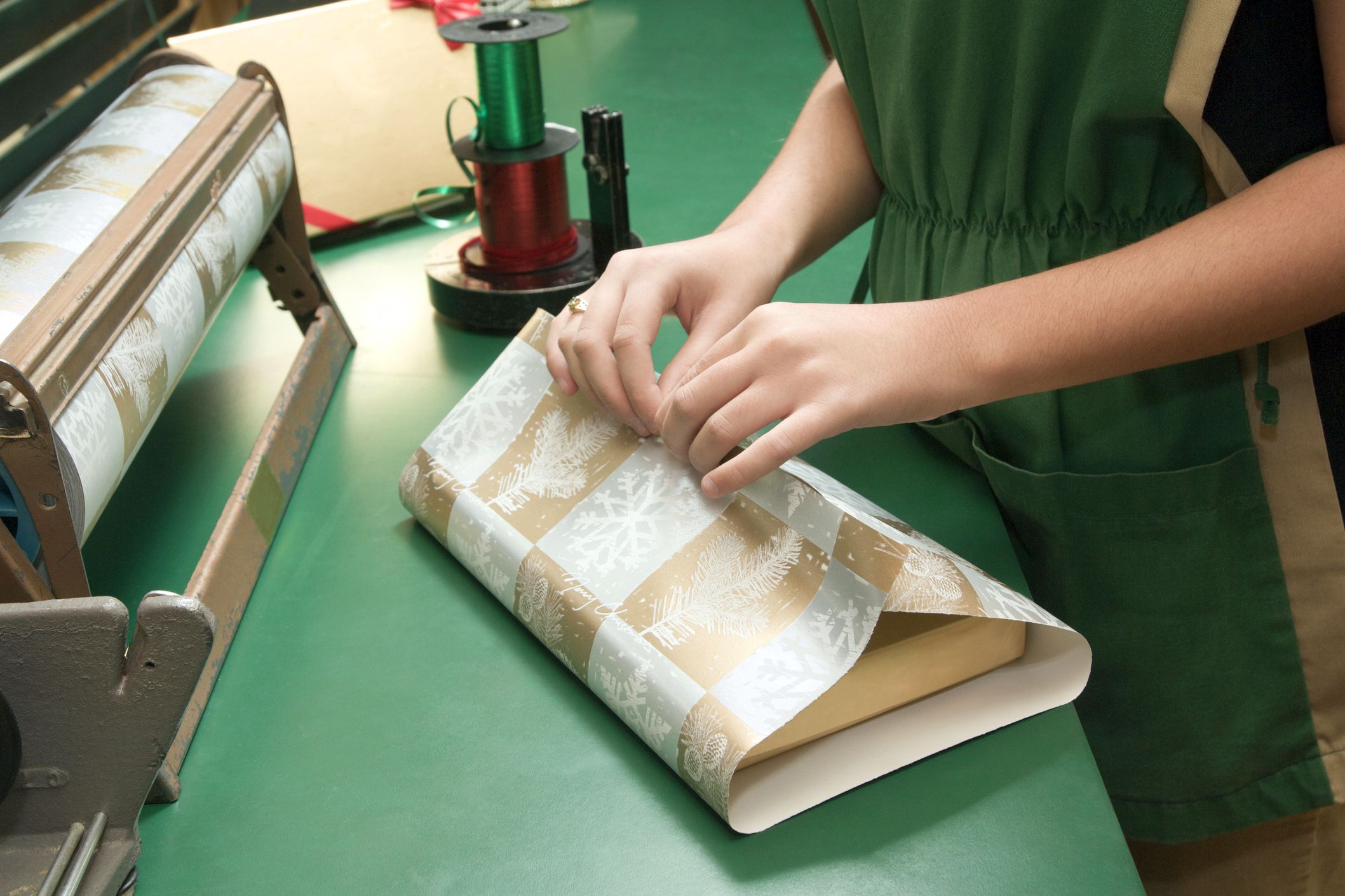 close-up of sales clerk wrapping holiday present