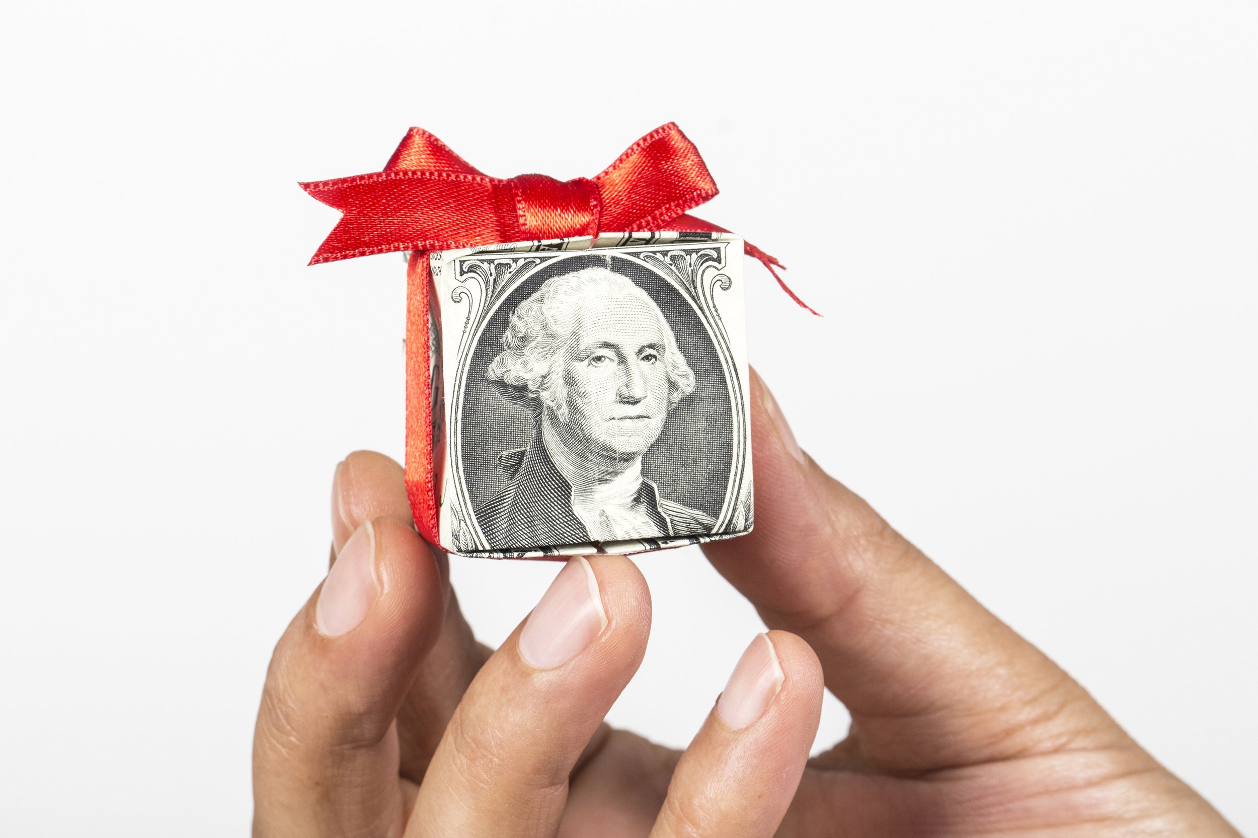 hand holding gift of dollar