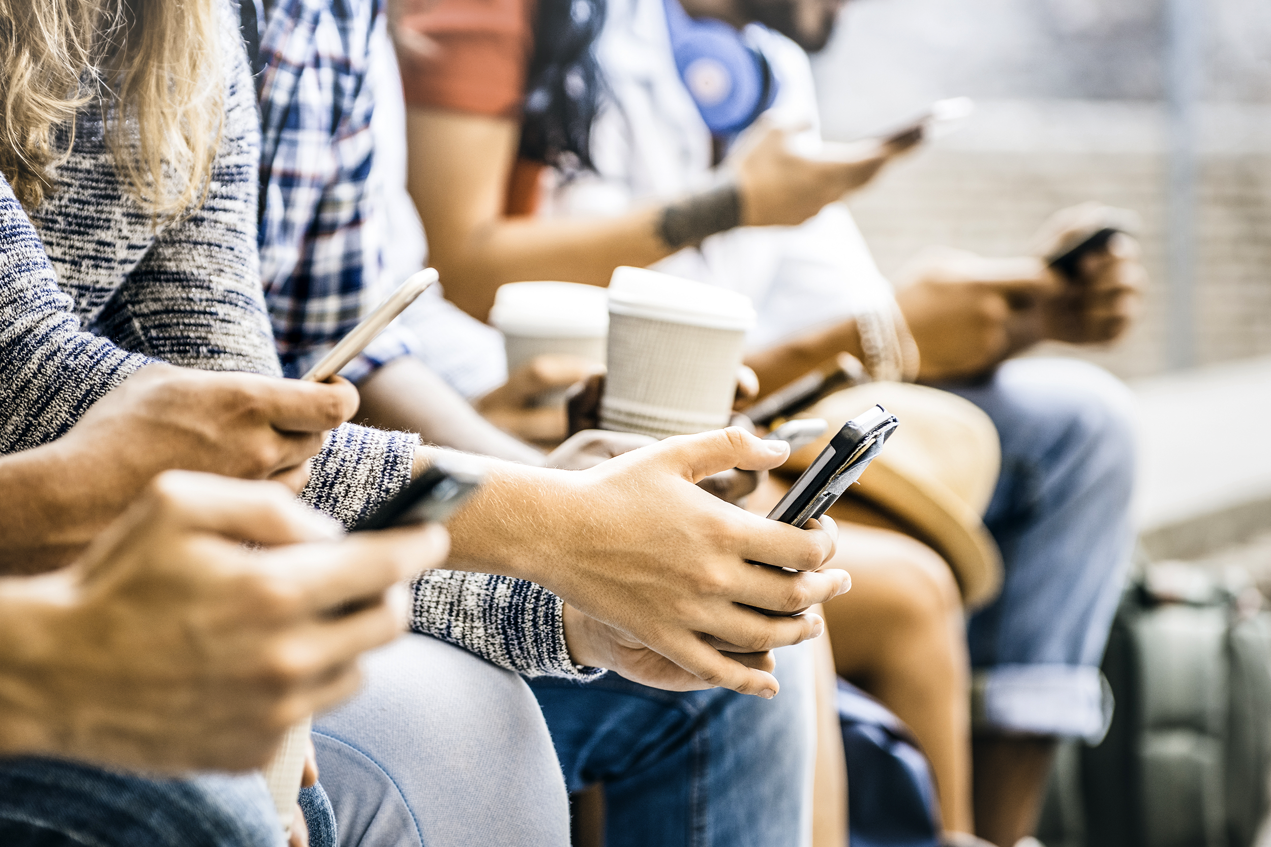 Group of people using their smartphones