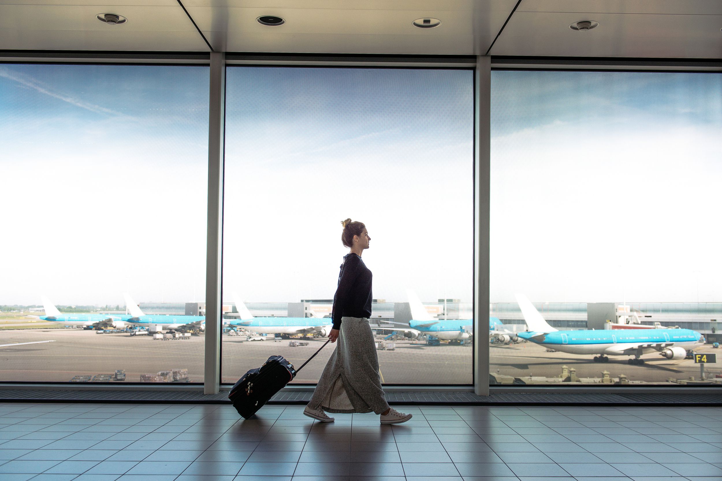 Woman walking through an airport terminal