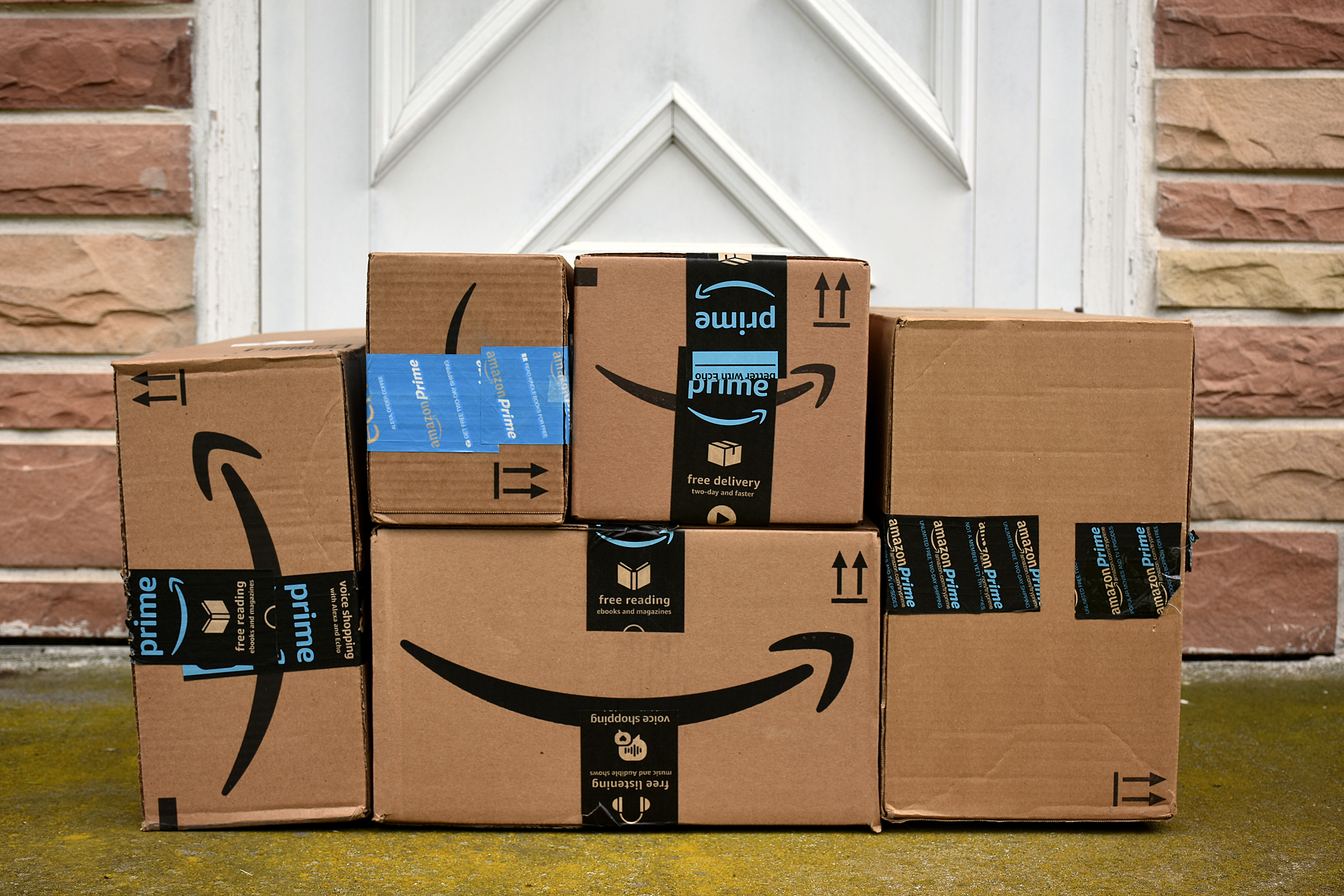 Stack of Amazon packages in front of a door