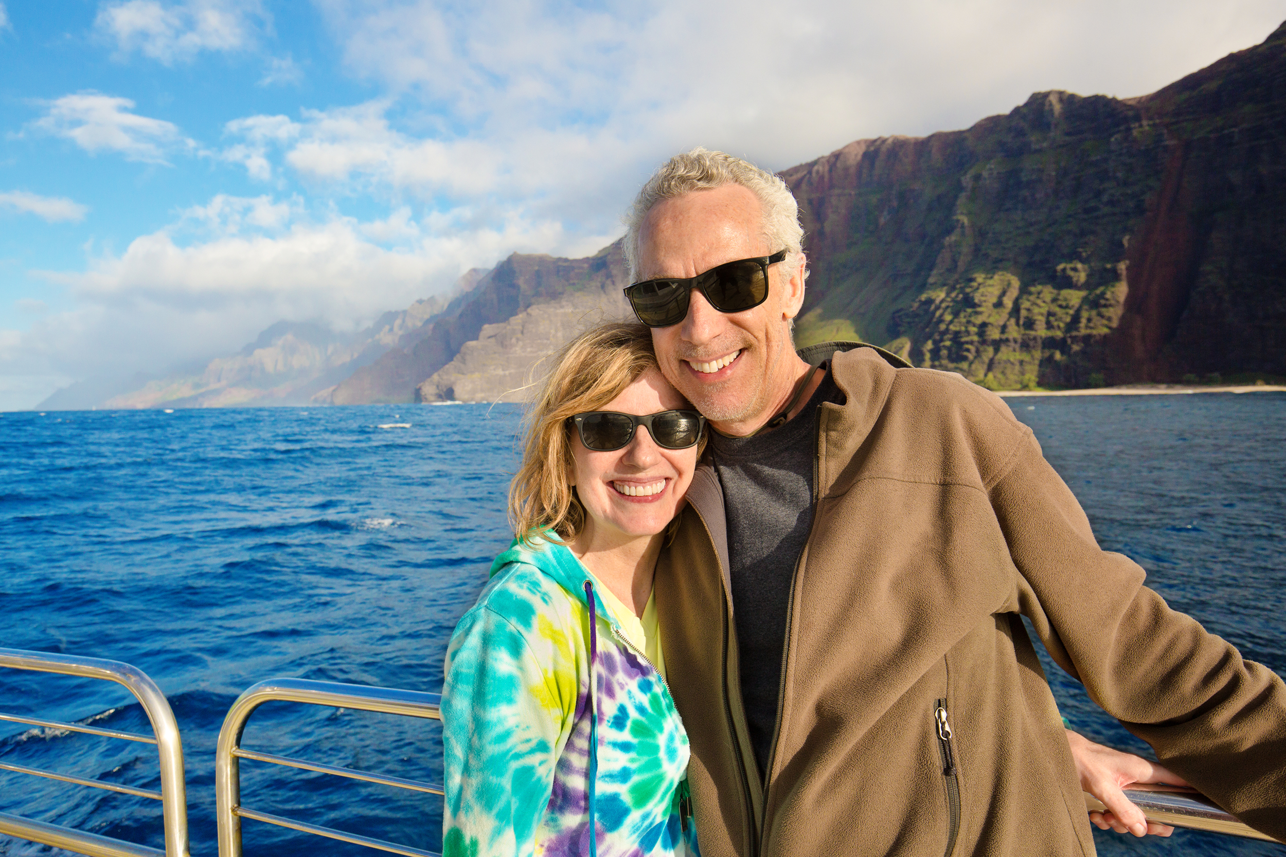 Older couple dressed informally on a cruise ship smiling at camera