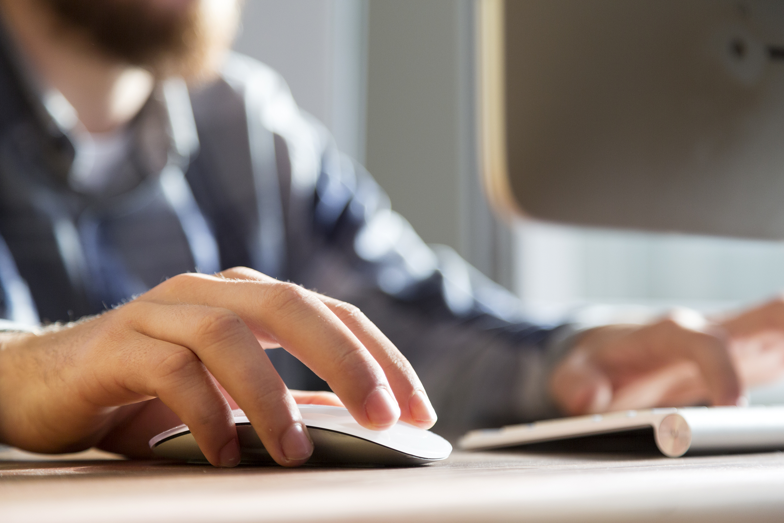 Closeup of man clicking his computer mouse