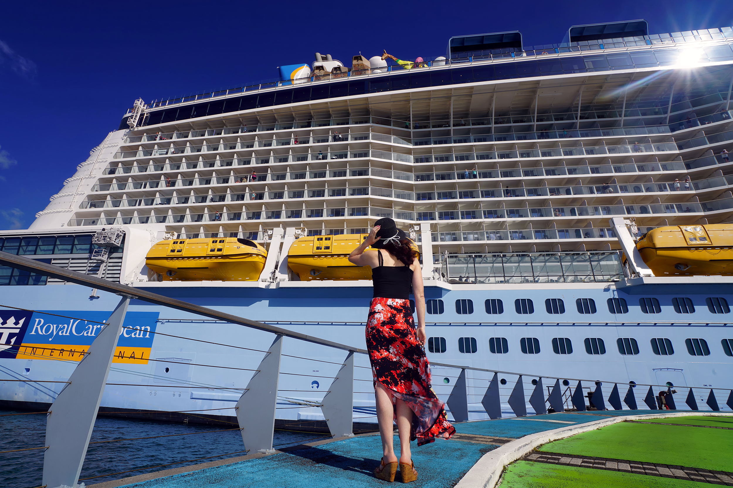 Woman standing in front of a huge cruise ship