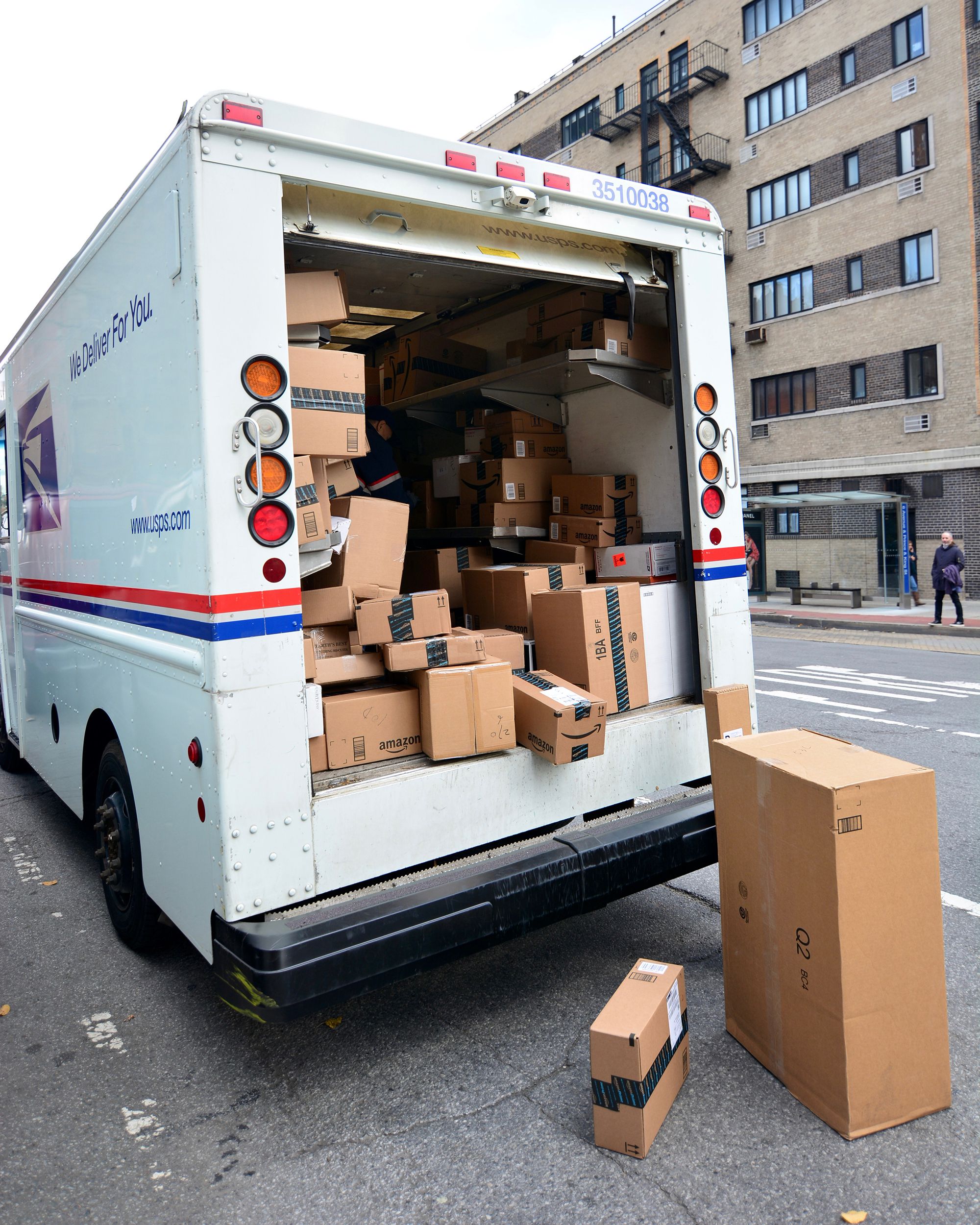 USPS Delivery man unloading boxes from truck