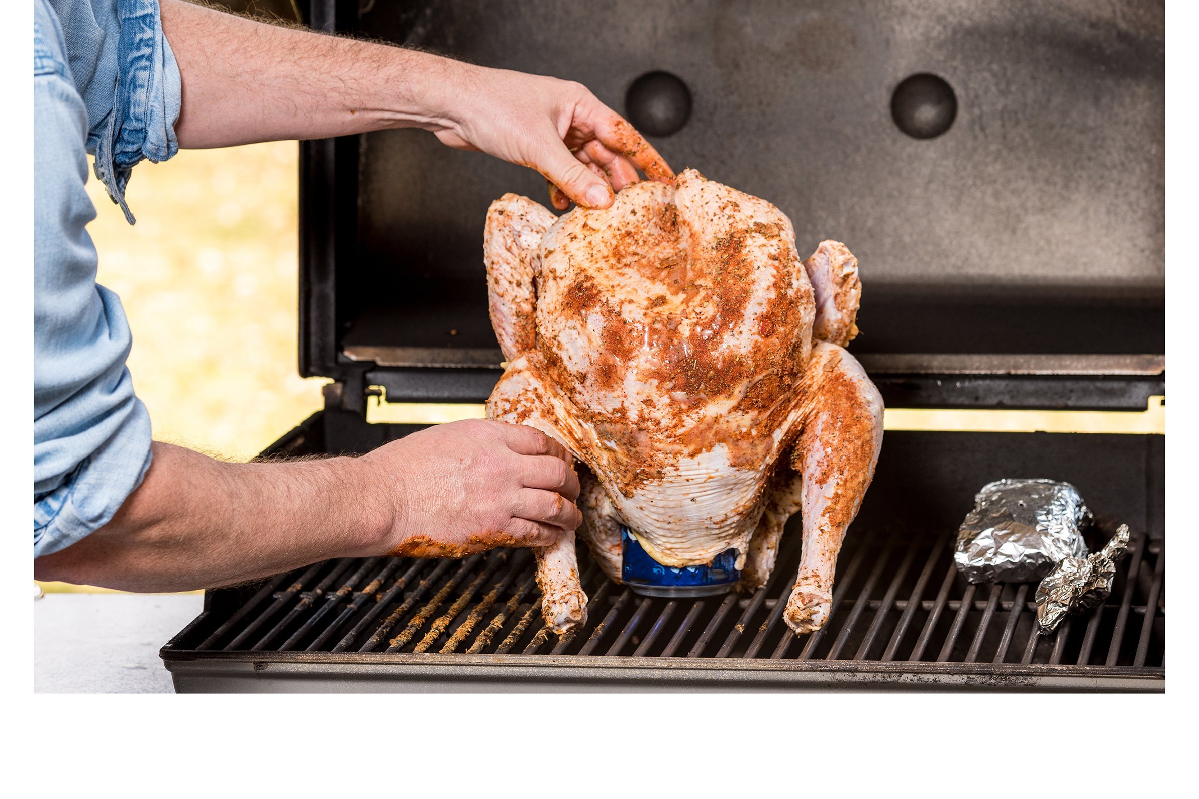 Turkey on top of a beer can on the grill