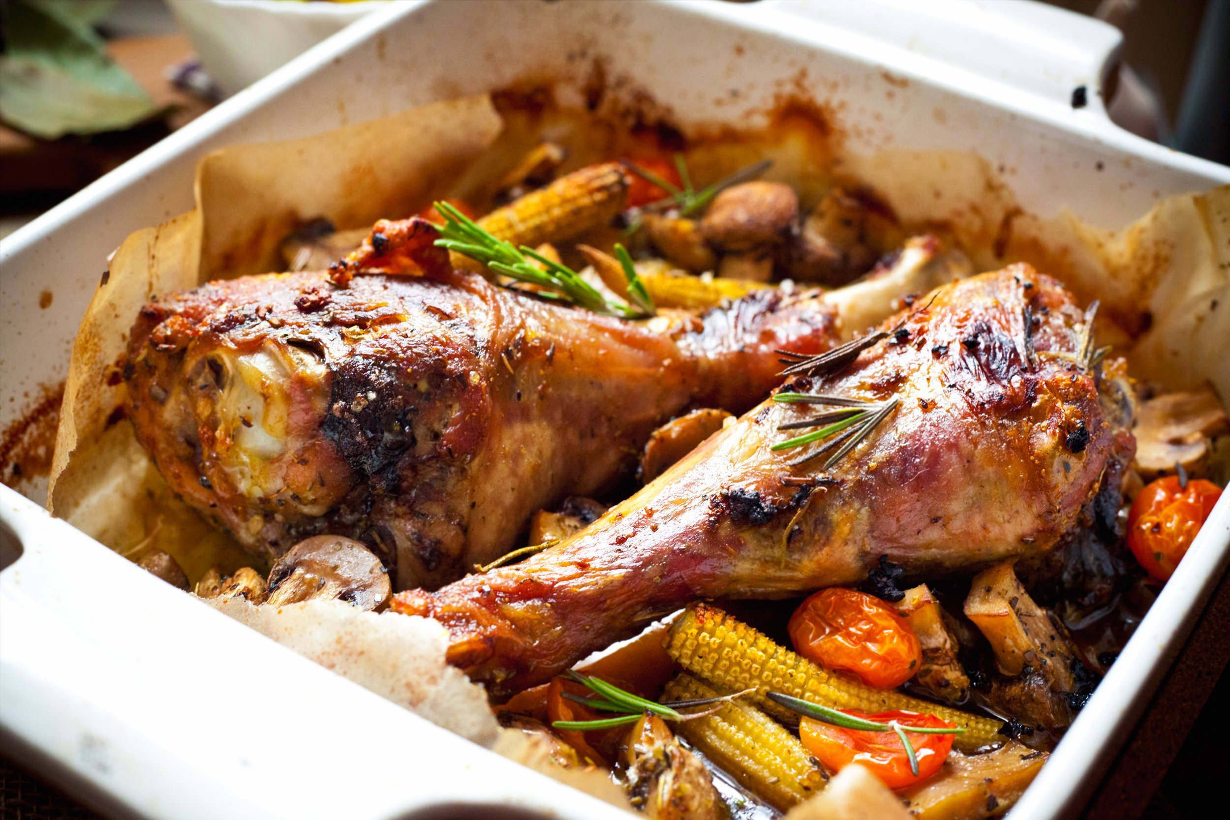 Braised turkey legs in a dish with roasted vegetables