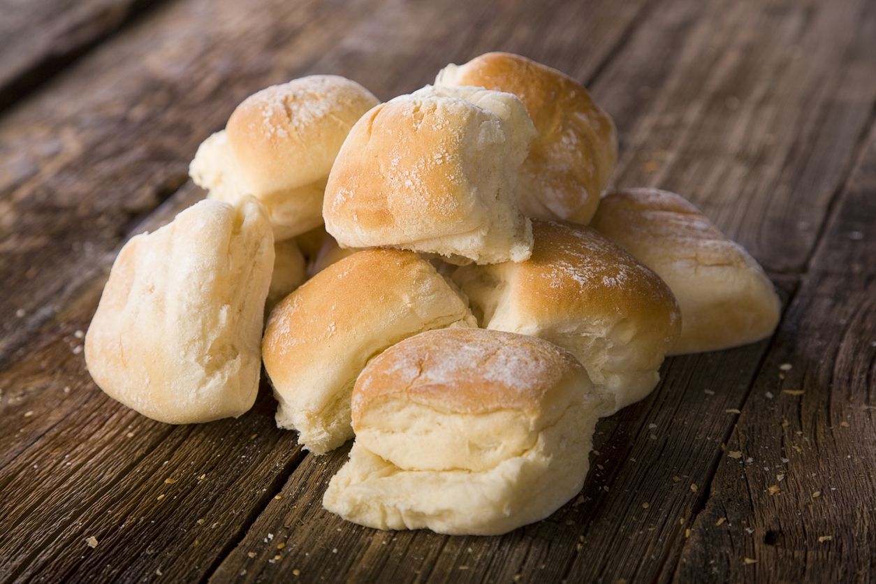 dinner rolls on wooden surface