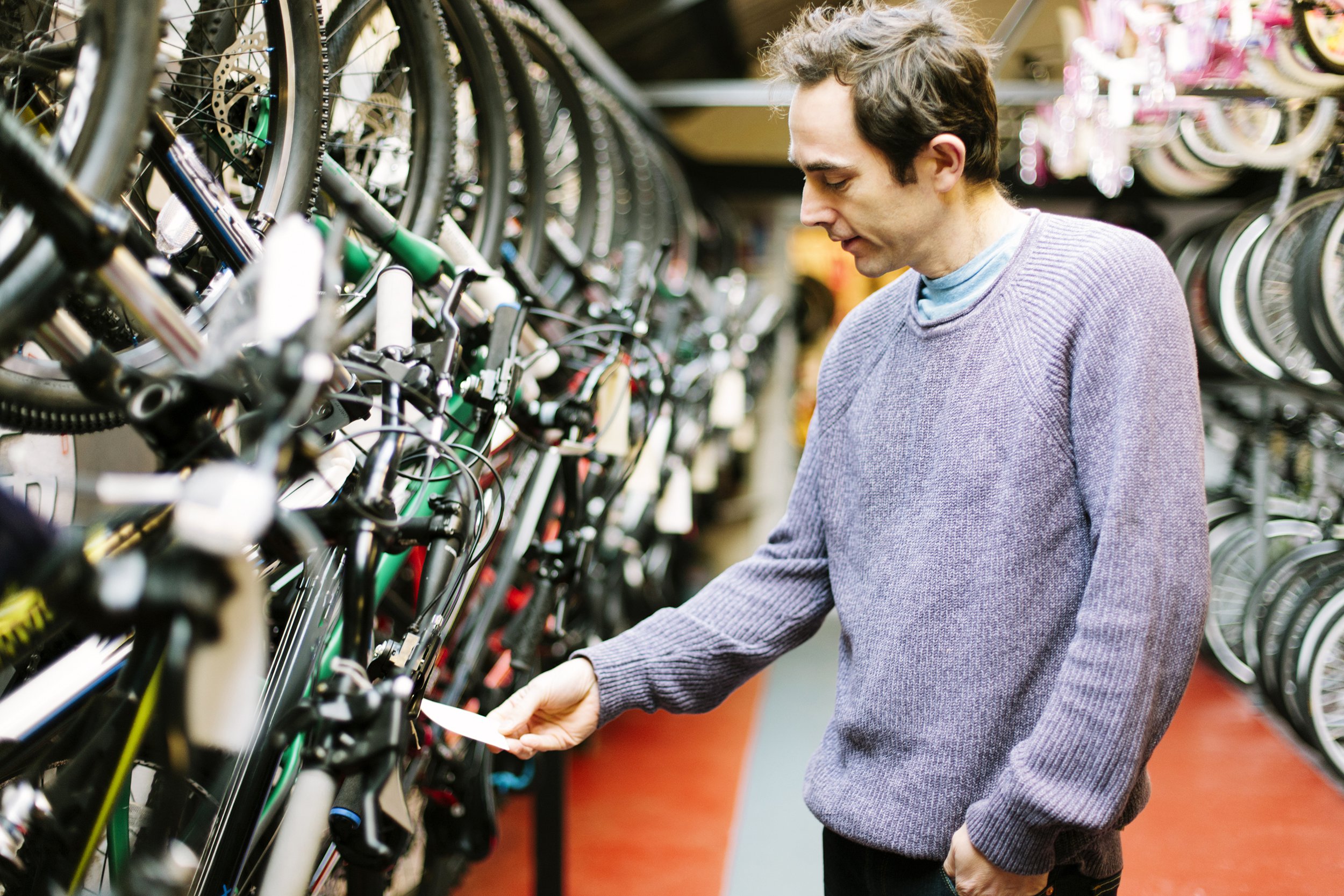 Man looking at price tag on a bike