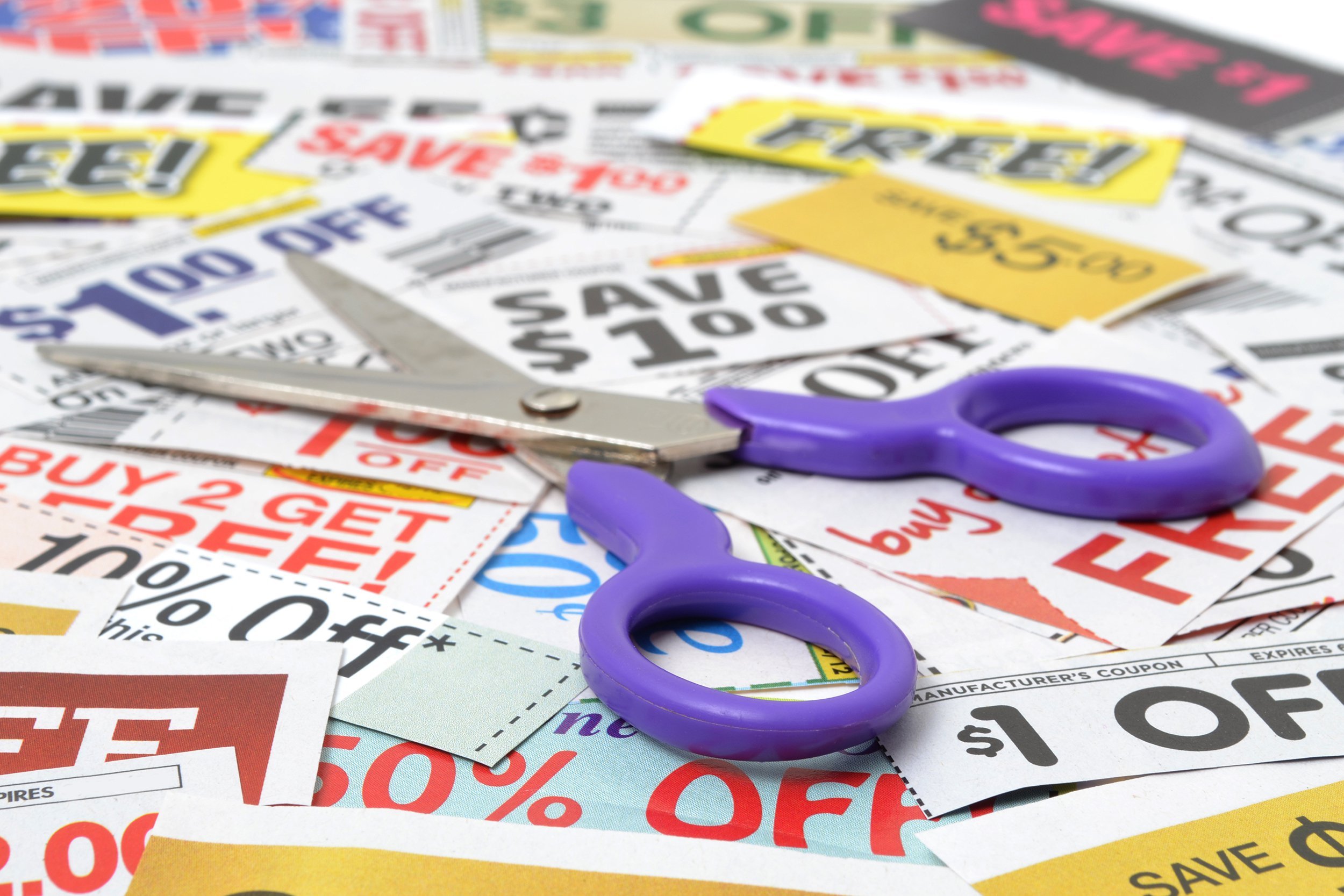 Scissors on top of a pile of coupons