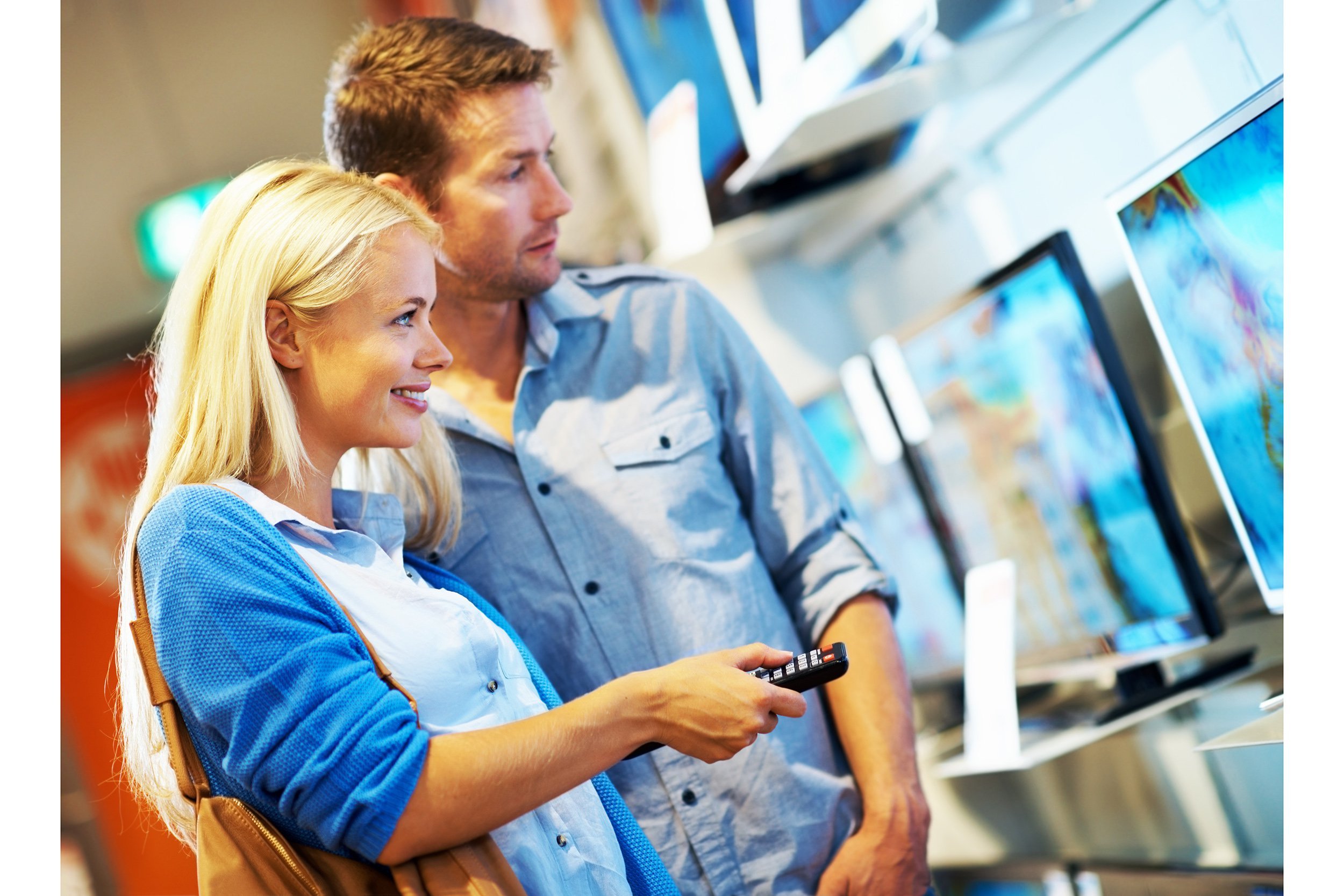 Couple looking at tvs in a store