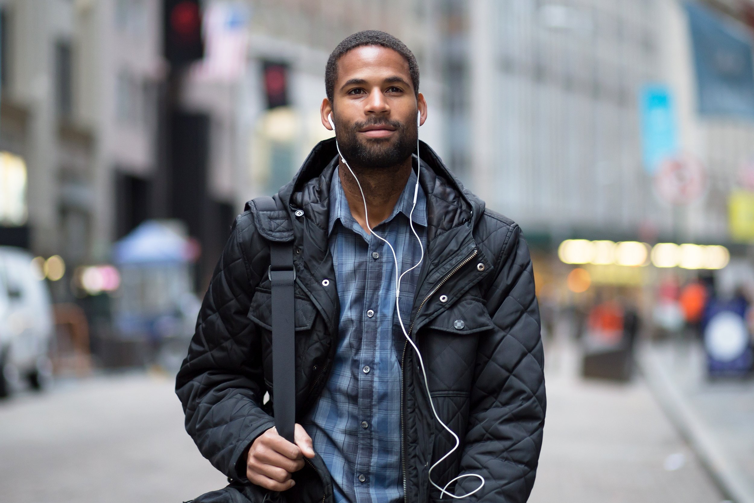 young African American man walking to work in NYC