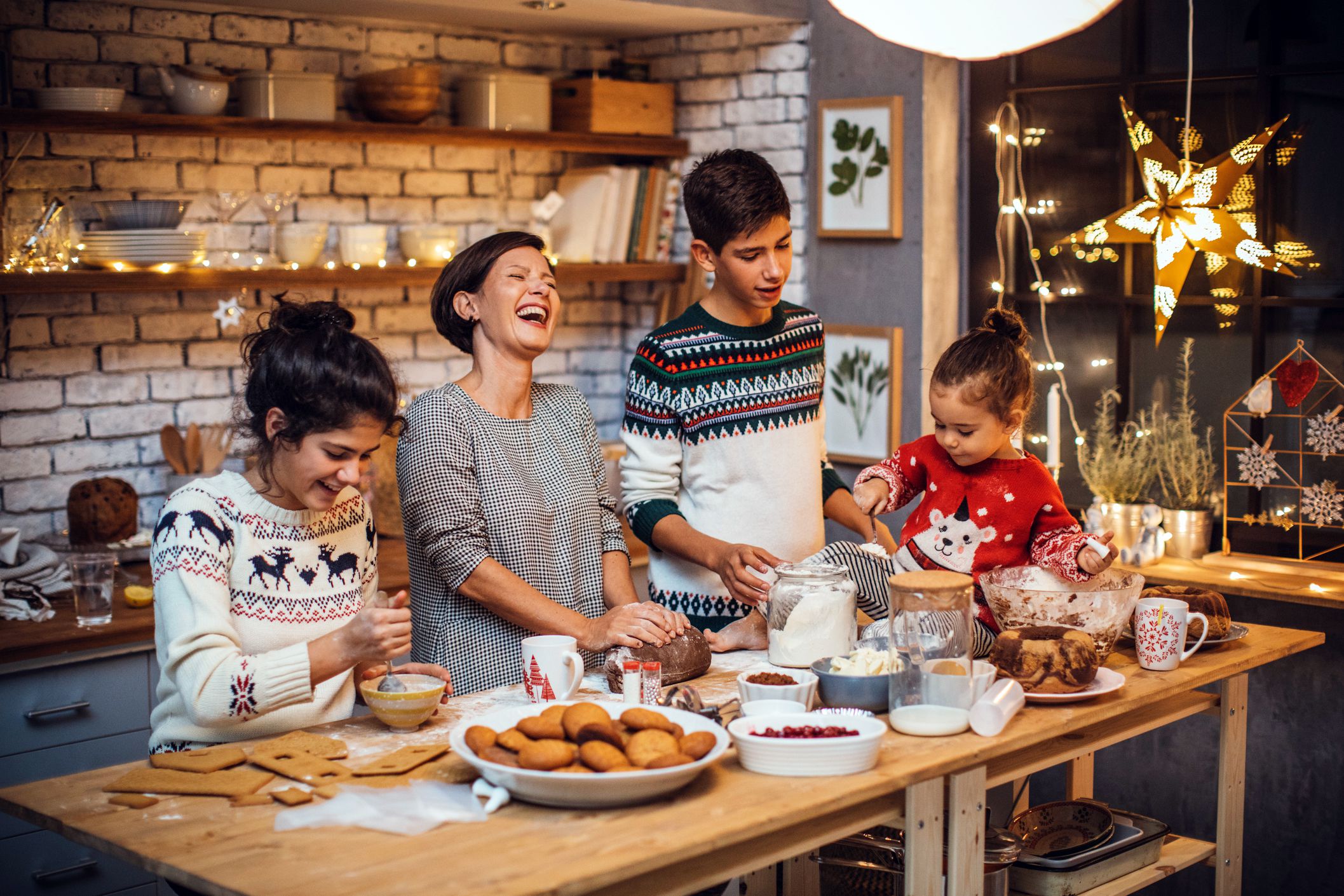 family happily preparing christmas cookies in festive kitchen setting