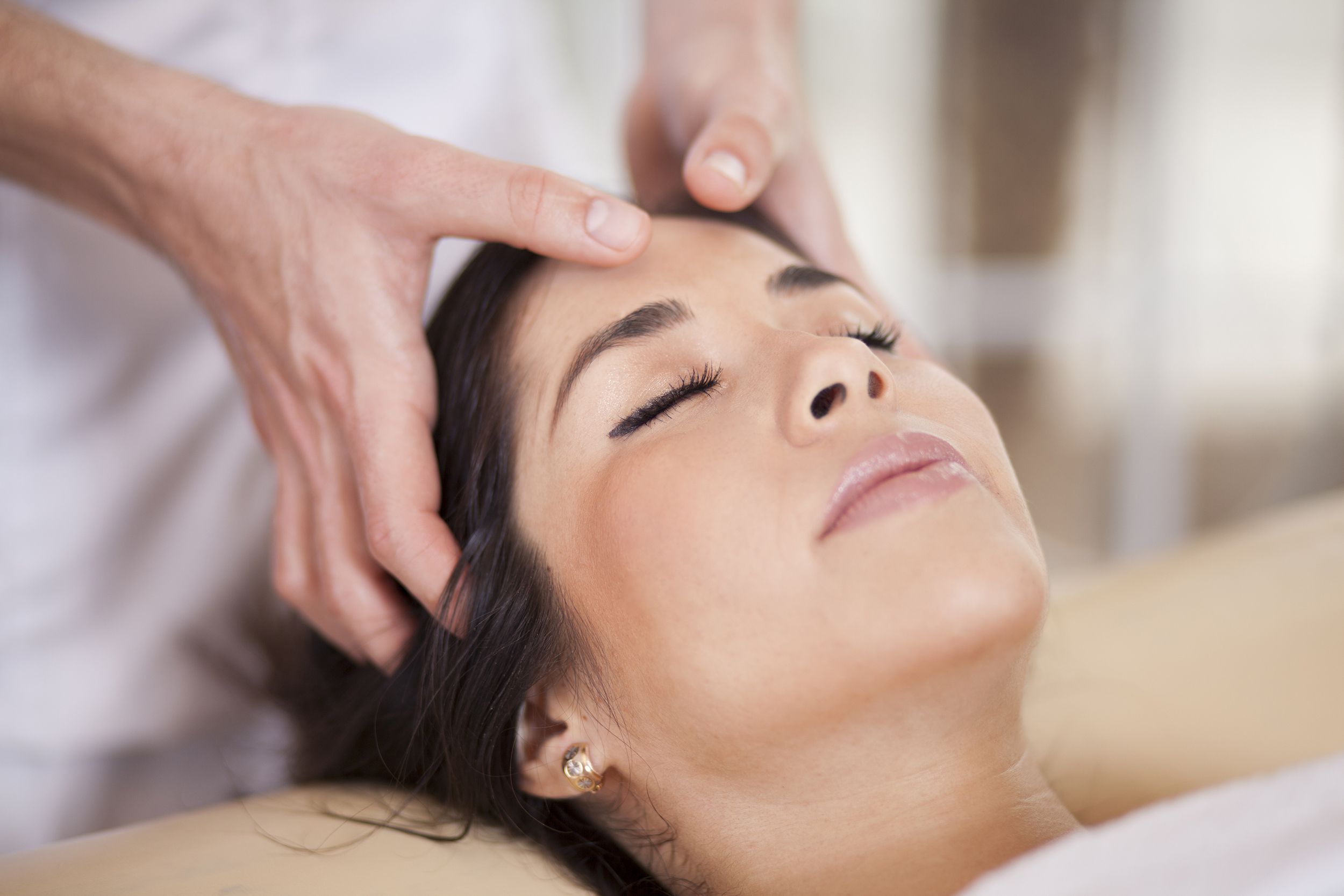 relaxed woman getting head massage
