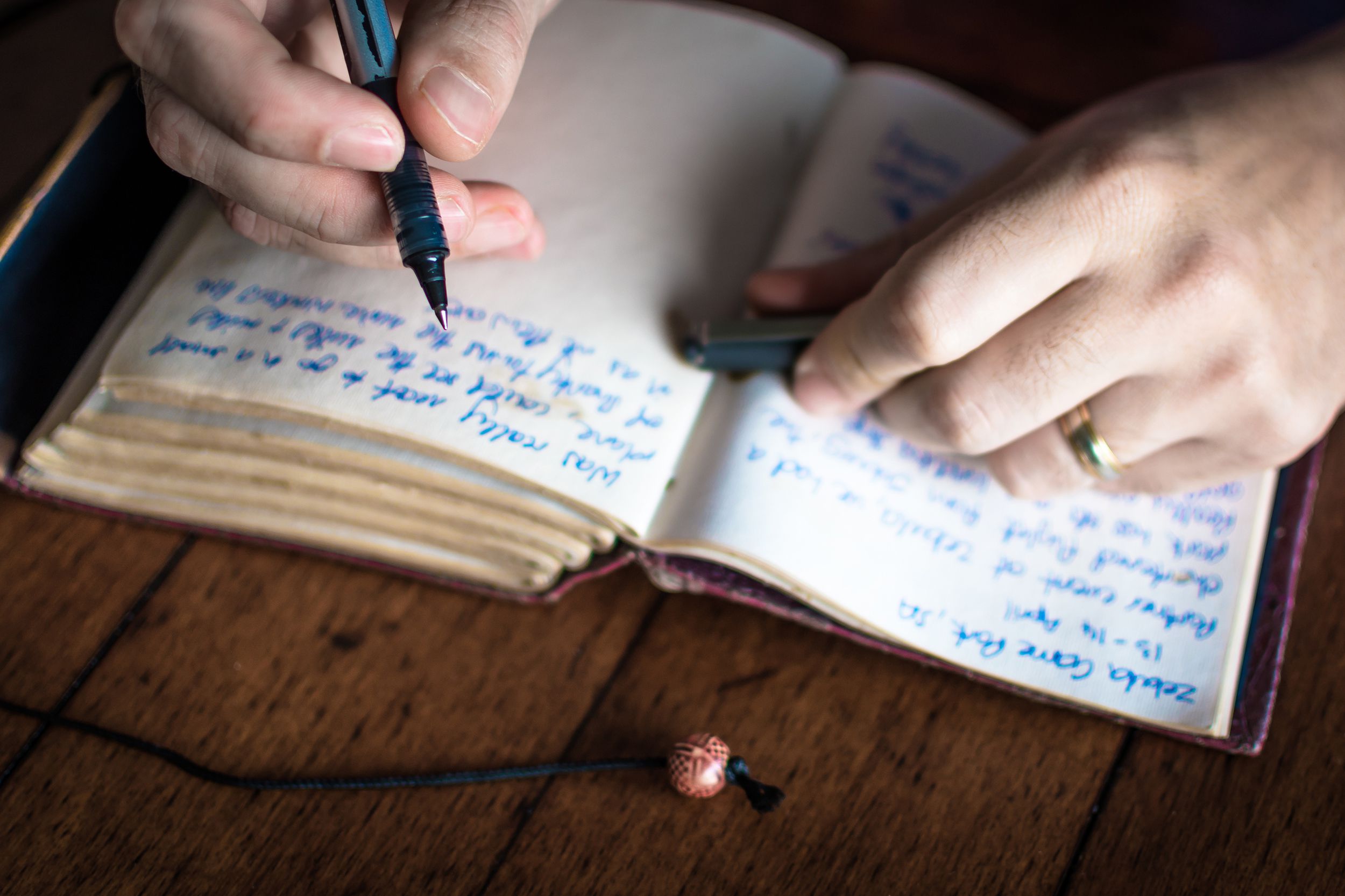 man writing in a journal