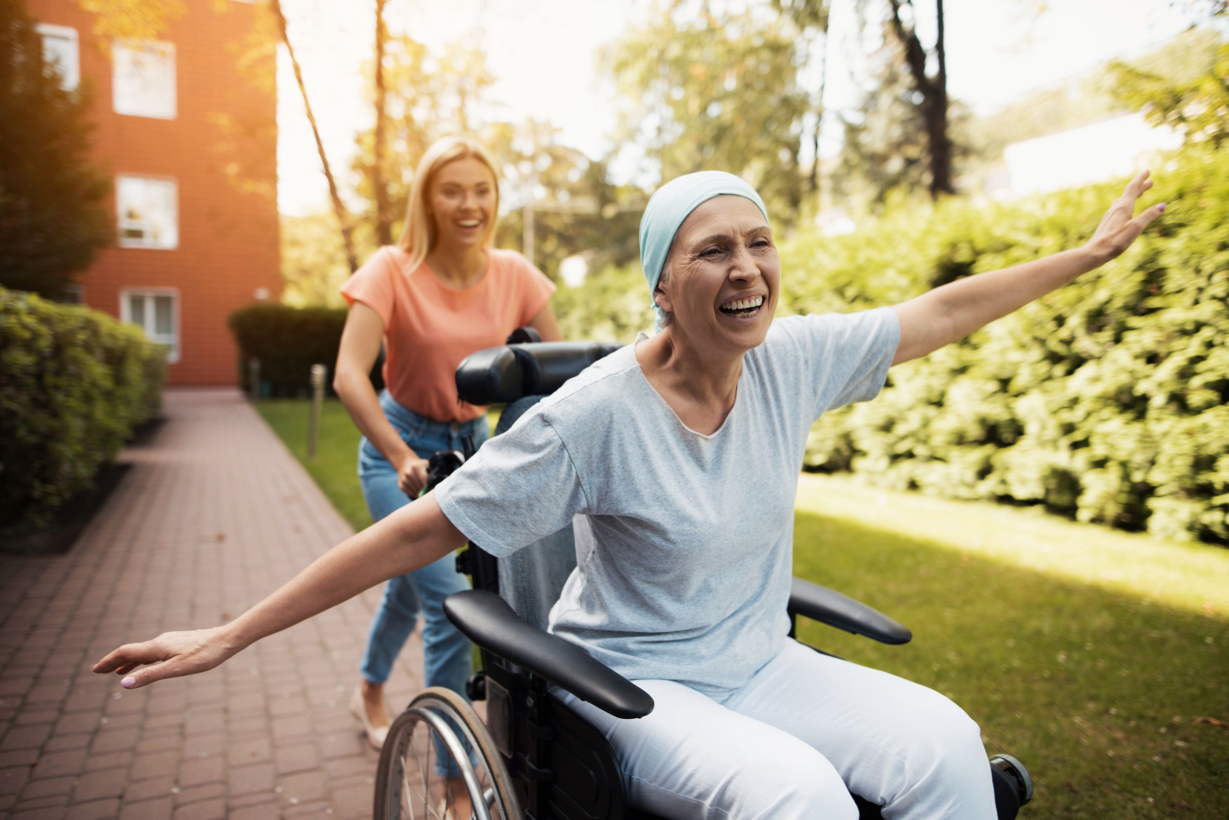 woman with cancer is sitting in a wheelchair