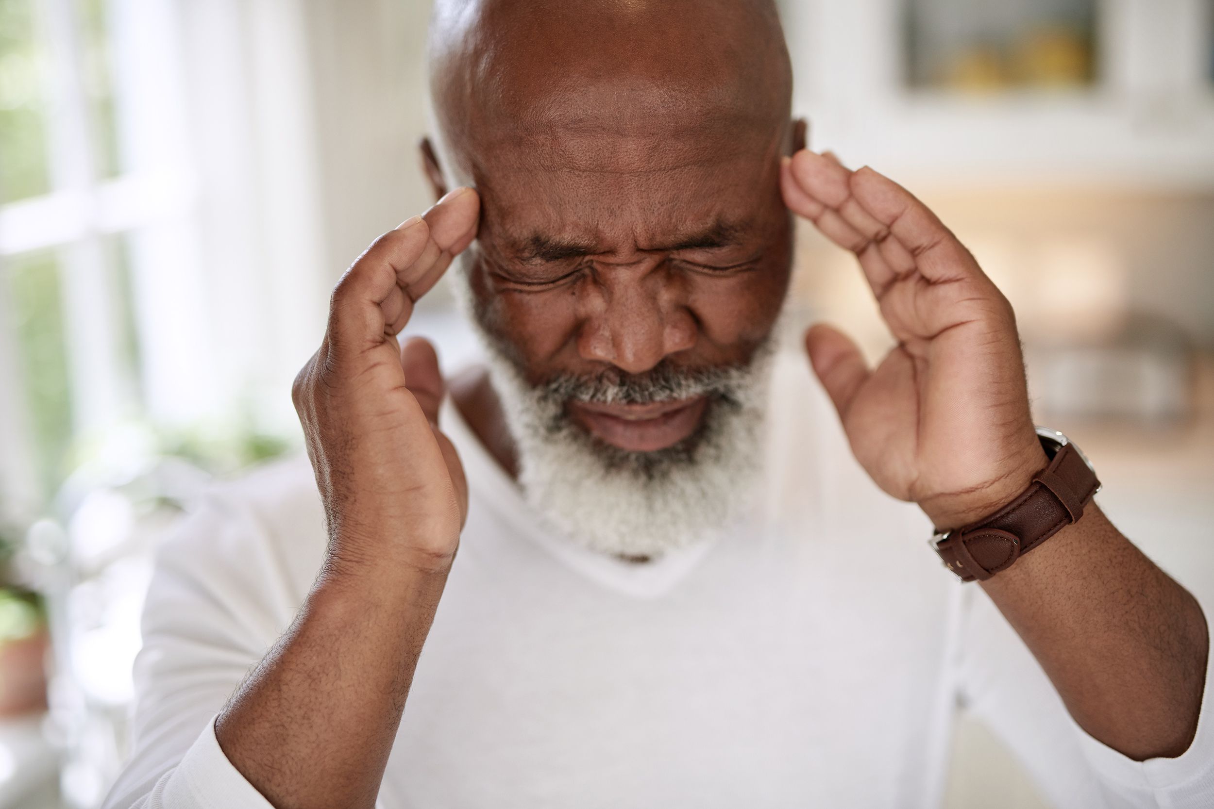 senior man with migraine